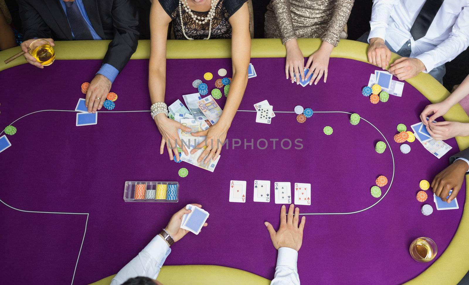 People playing poker woman grabbing money