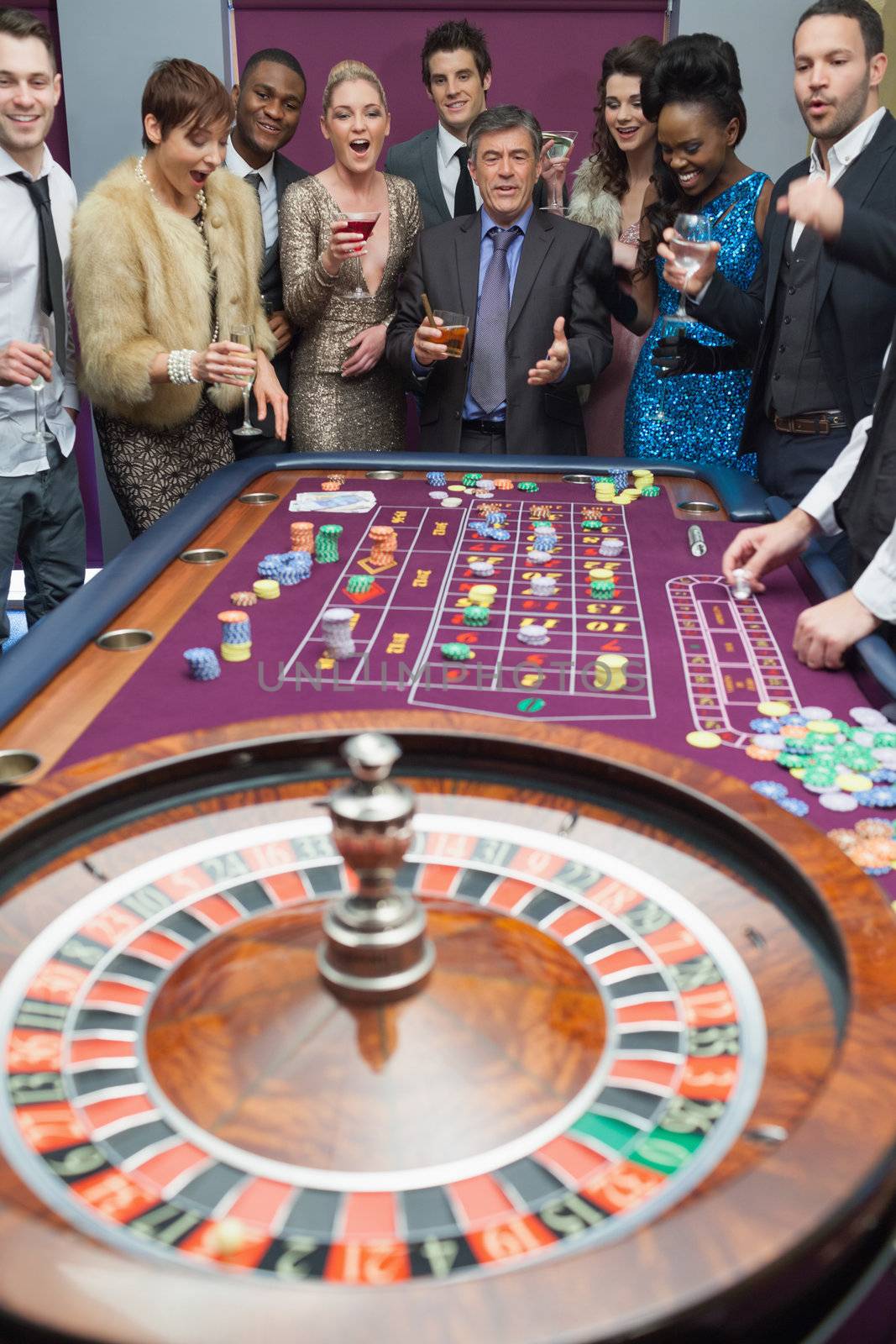 People standing at the roulette table by Wavebreakmedia