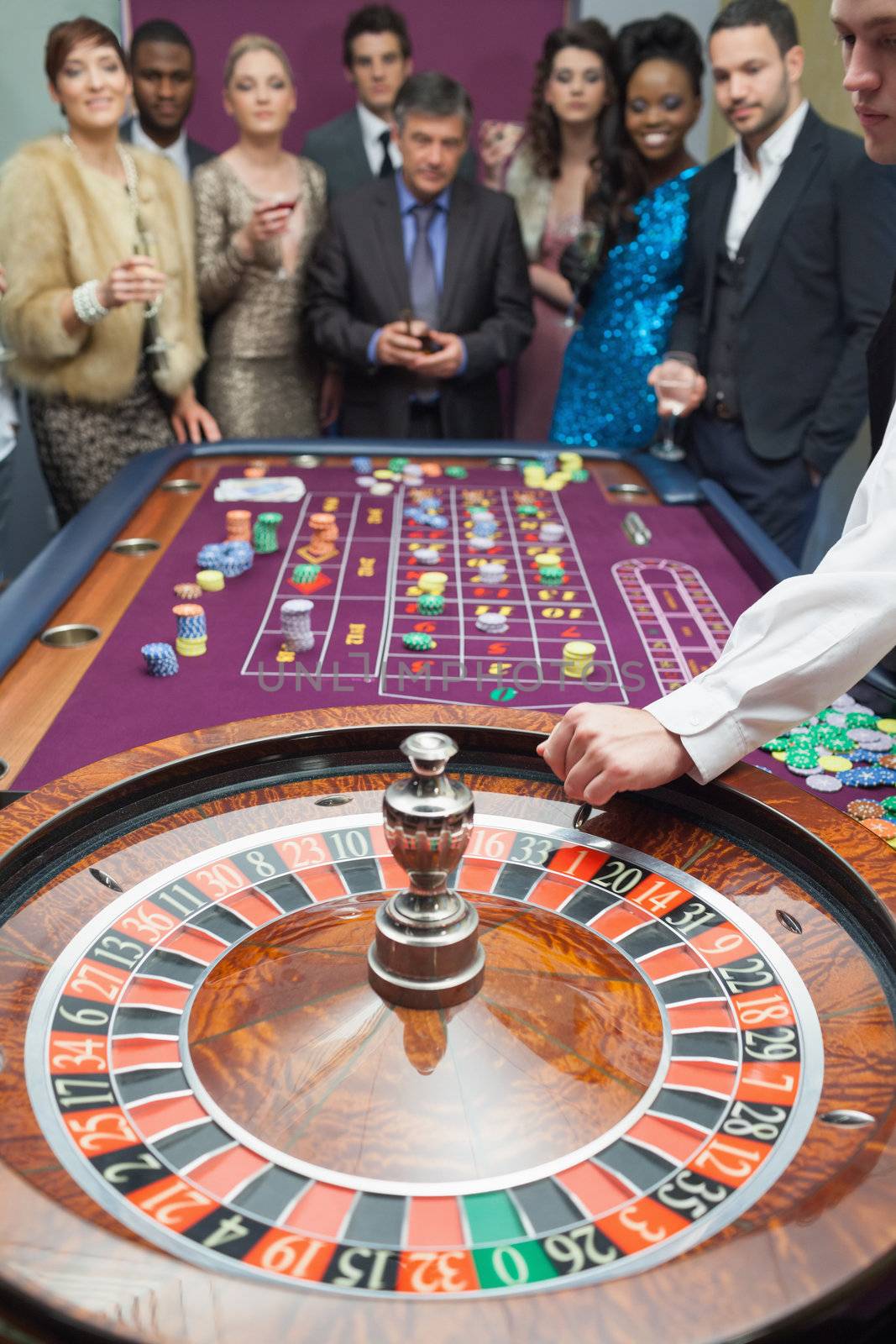 People standing at the roulette table in casino