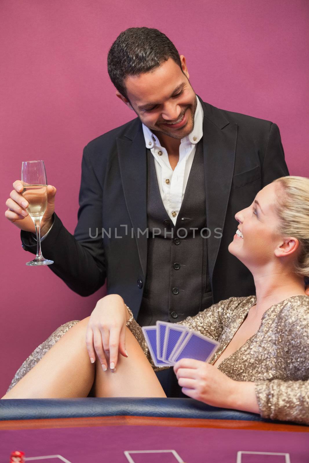 Two people flirting at poker table in casino