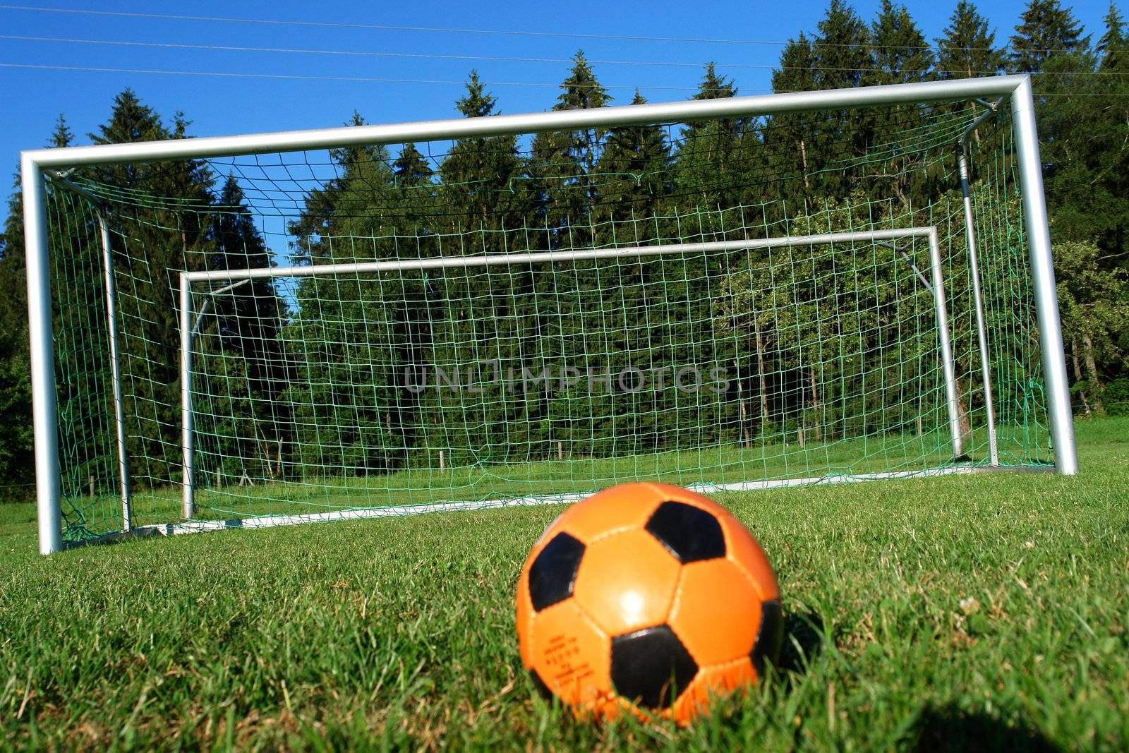 Goal. a soccer ball in a net. outdoors