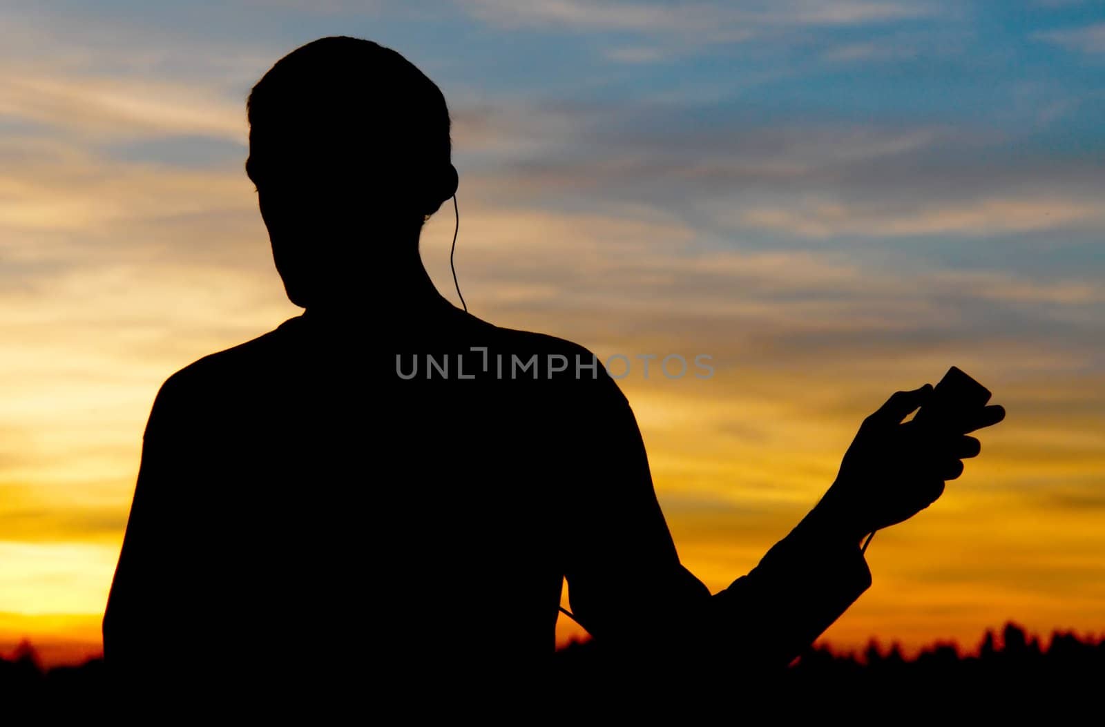 A person listening to the music again sunset A person listening to the music again sunset