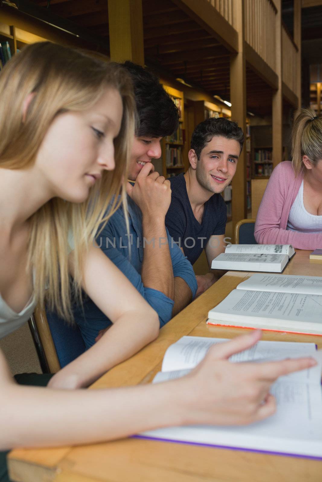 Students in the library in a study group by Wavebreakmedia