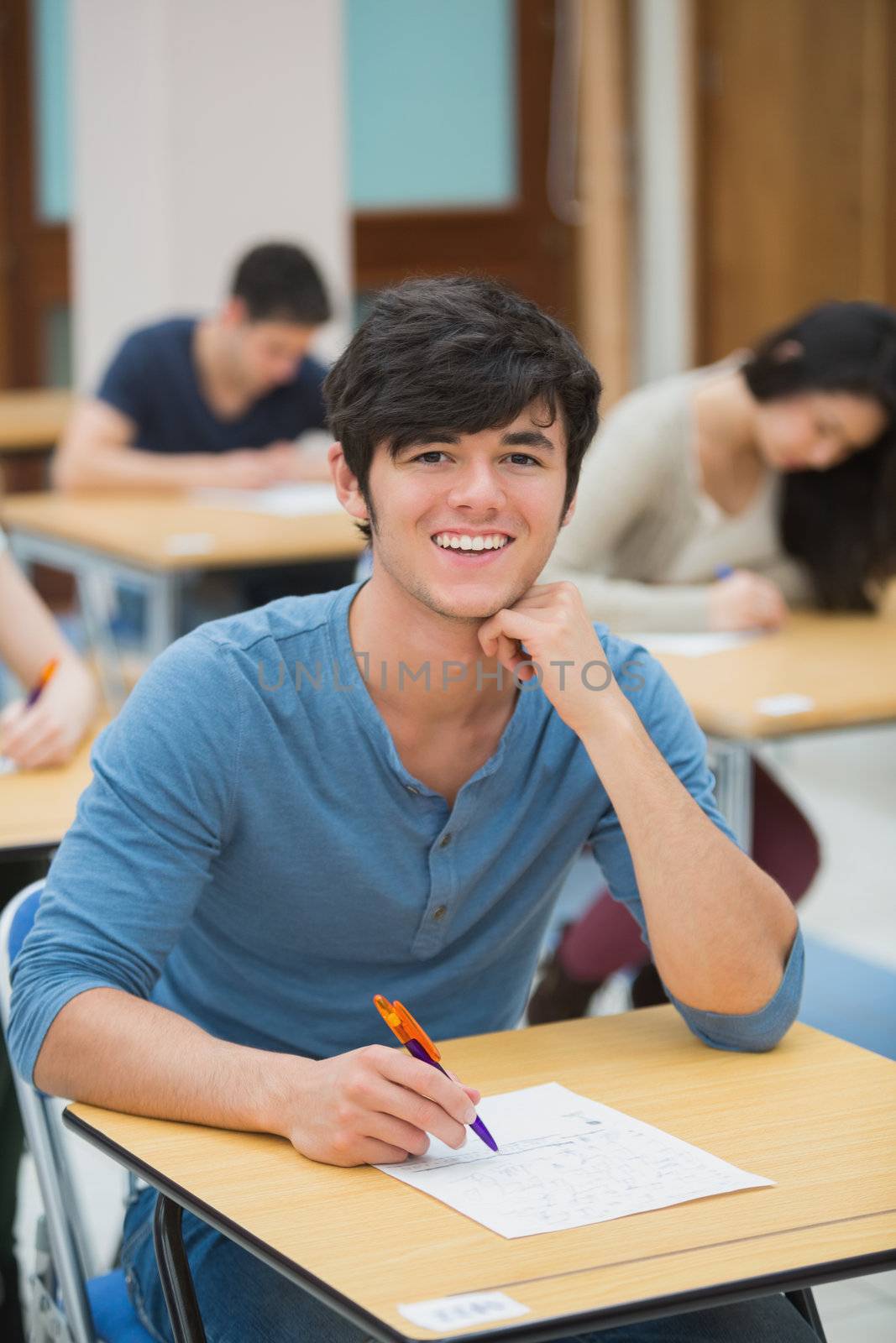 Student smiling during exam by Wavebreakmedia