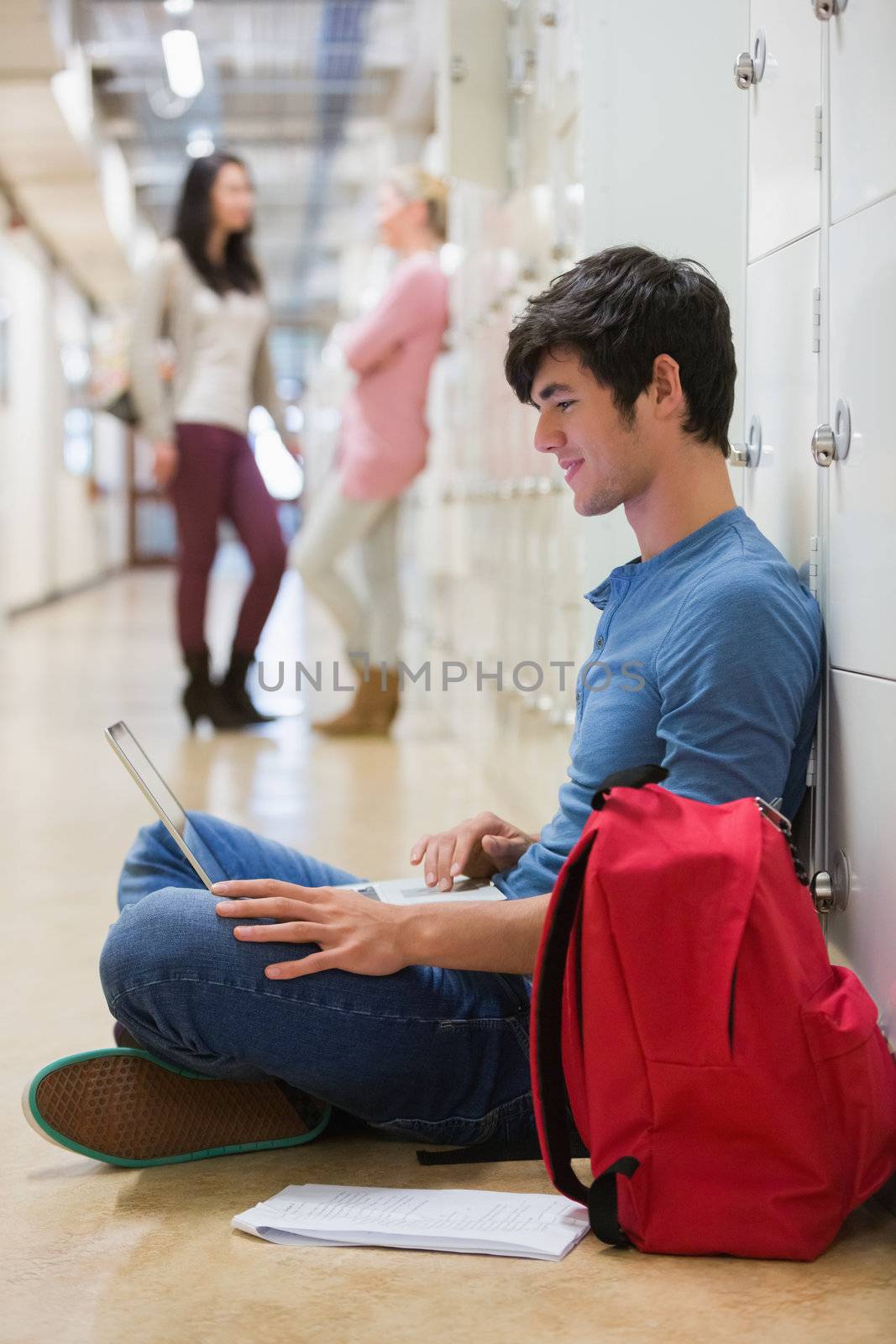 Man sitting on the floor at the hallway by Wavebreakmedia