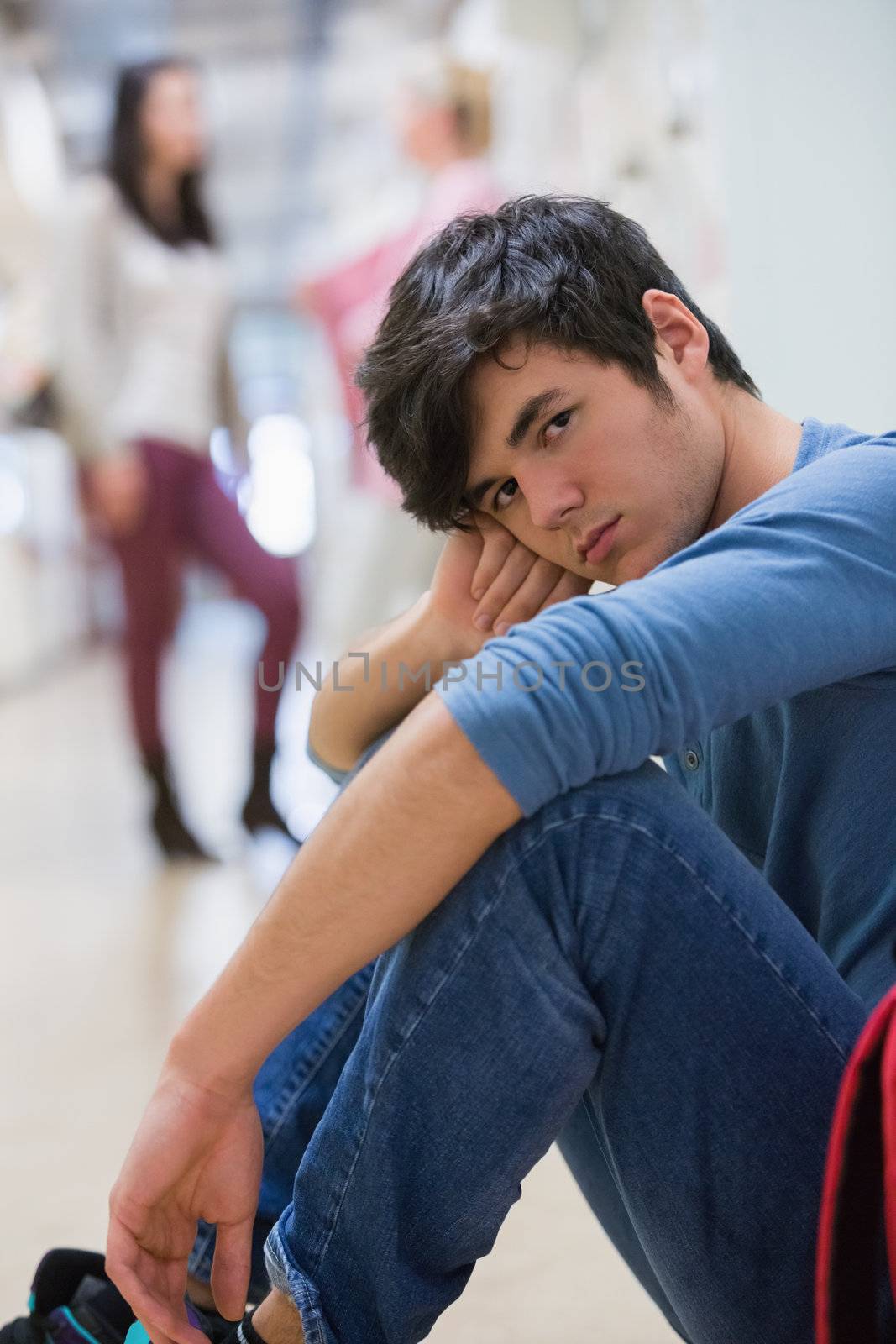 Man sitting on the floor looking disappointed