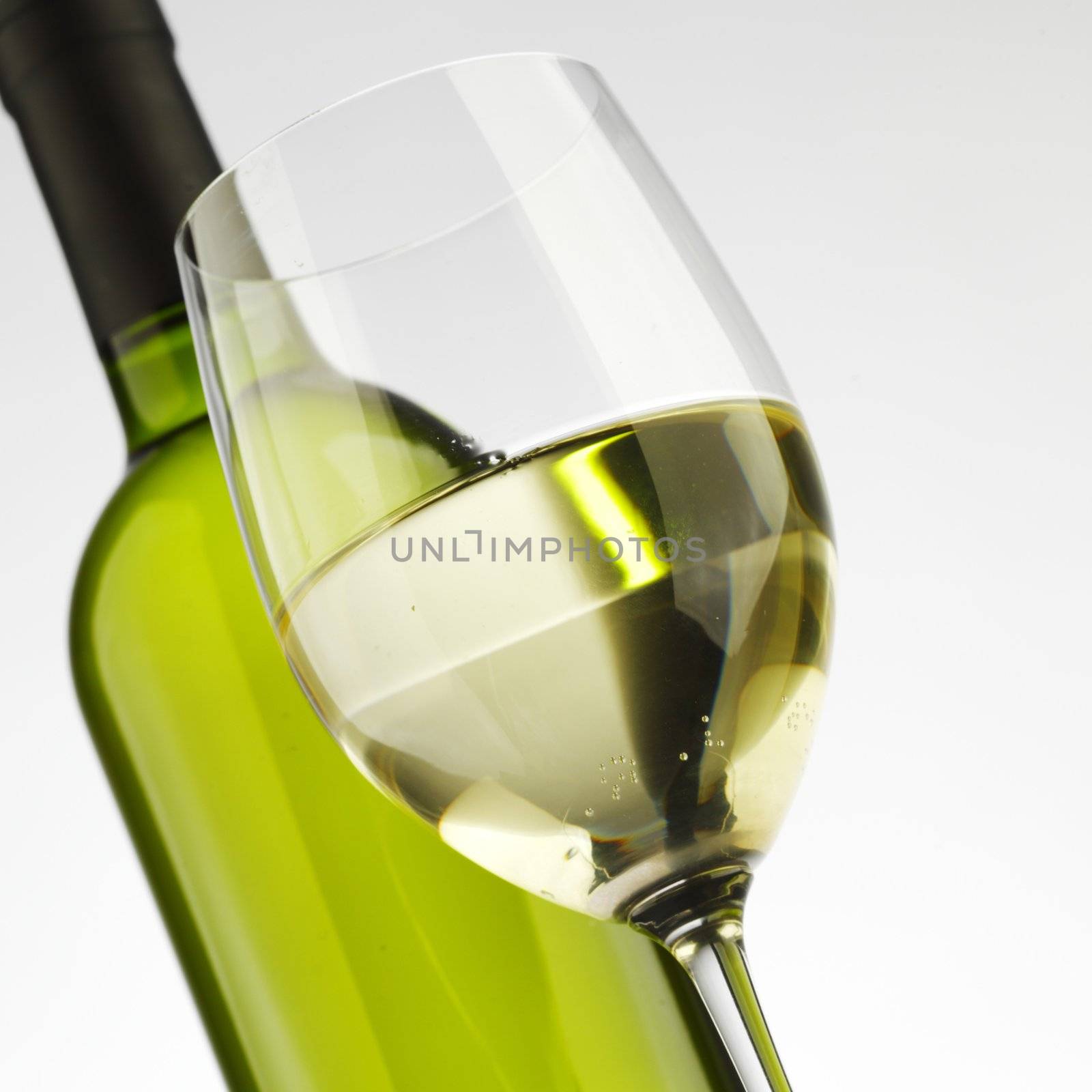 bottle with white wine and glass