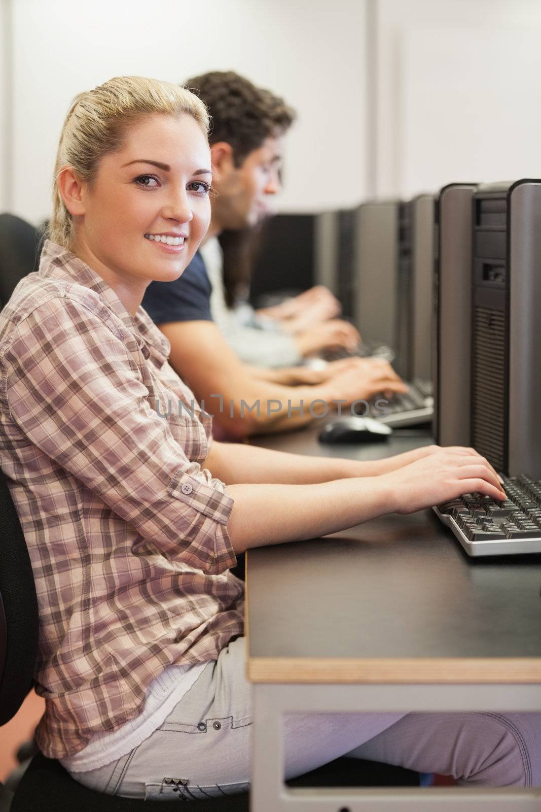 Students sitting at desk while typing in computer class
