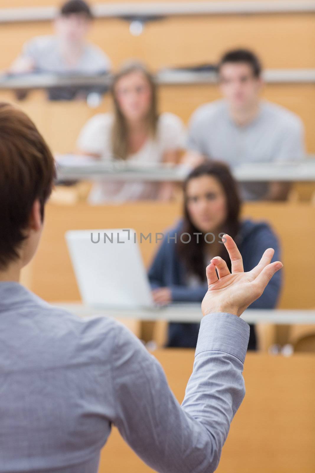 Teacher is talking to the students at the lecture hall