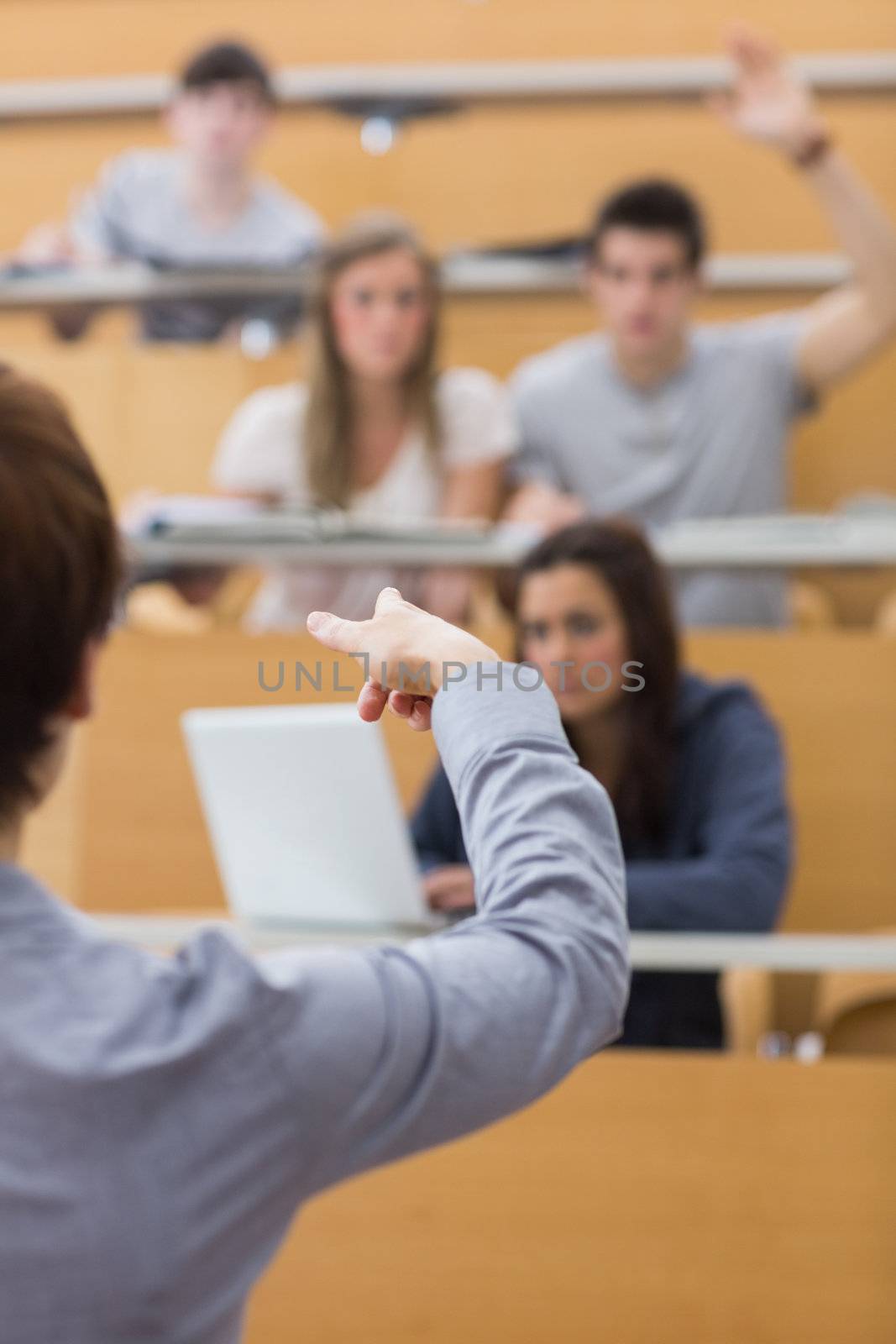 Teacher pointing to the man at the lecture hall 