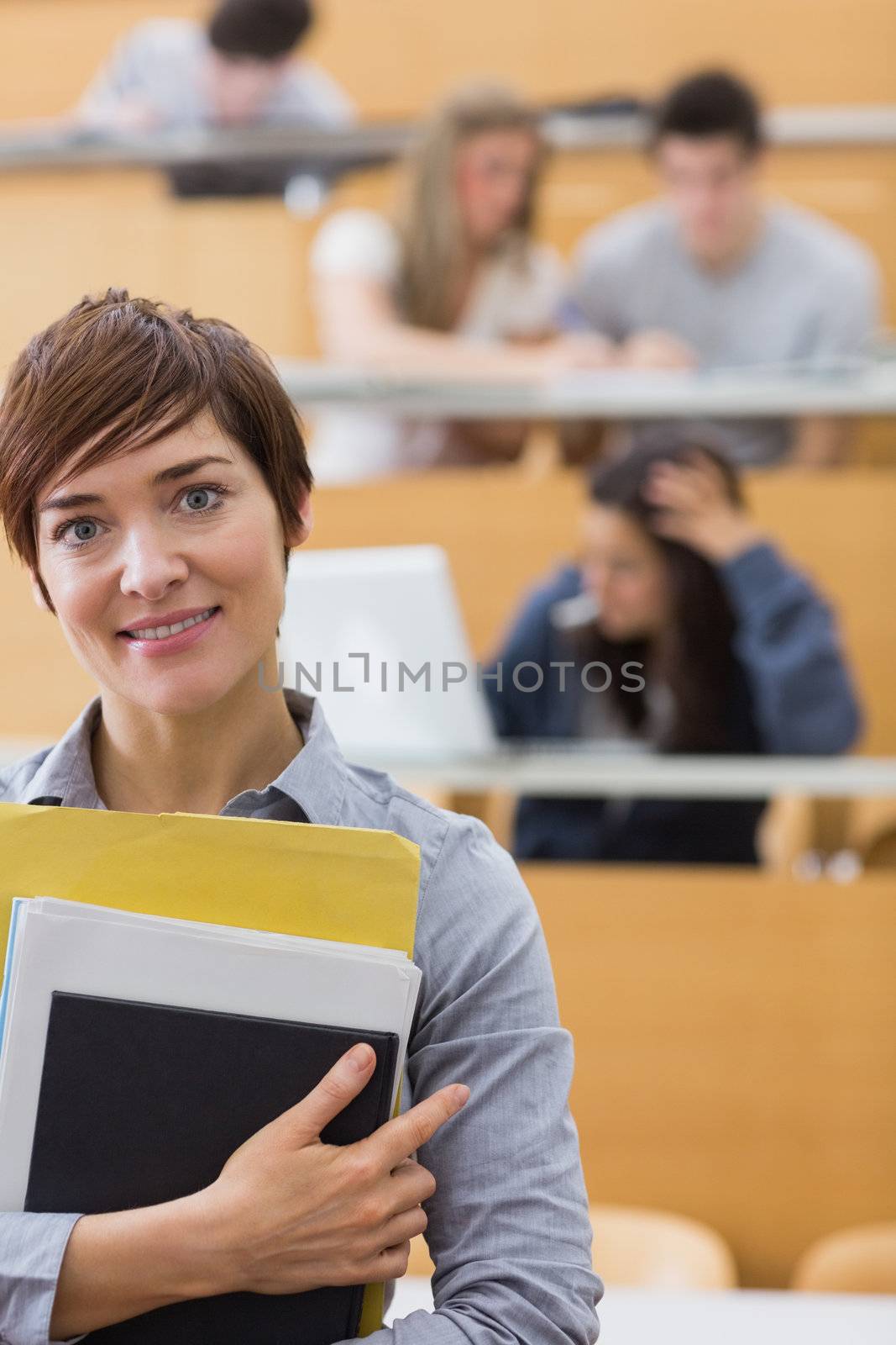 Teacher standing at the lecture hall by Wavebreakmedia