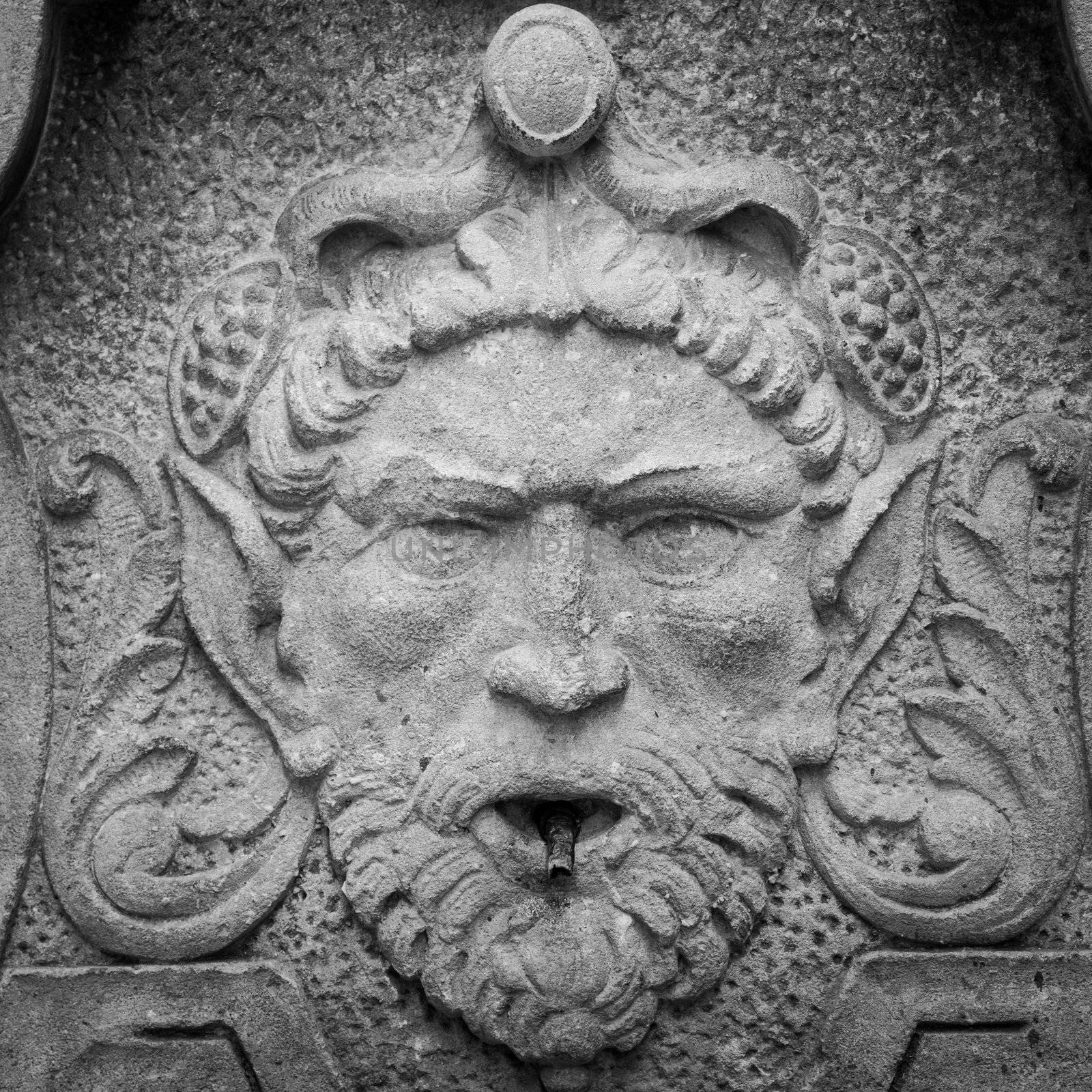 Dolceacqua town, Italy. Medieval fountain with elf head, 13th century