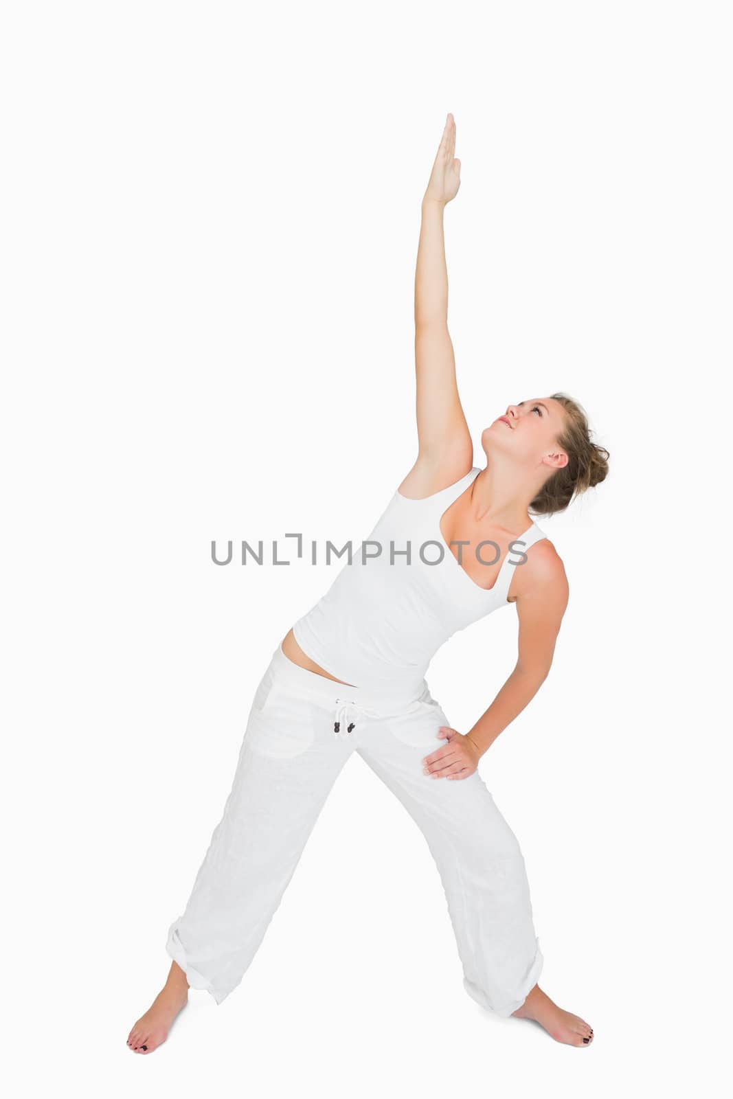 Woman in extended triangle yoga pose by Wavebreakmedia