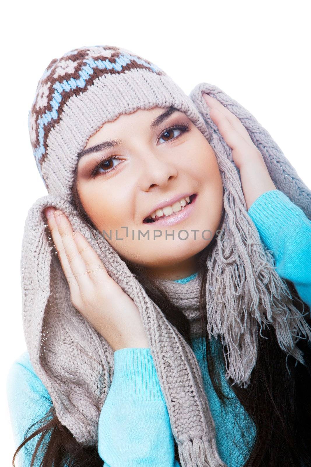 Smiling winter woman in a cap on the blue background