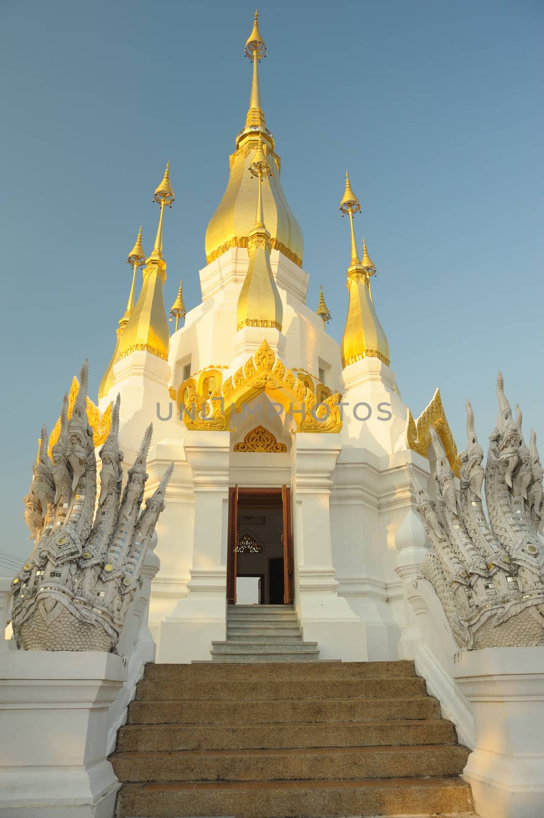 Sunrise the golden pagoda at the top in temple near Mekong river, Thailand. by ngungfoto