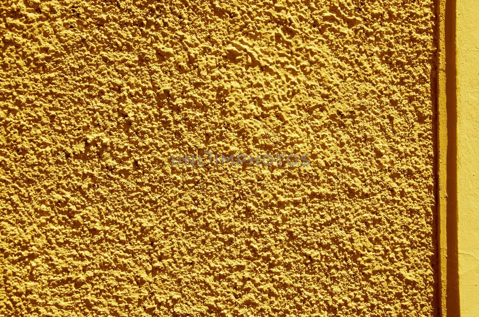 Yellow-painted textured walls macro closeup. Architectural background details.