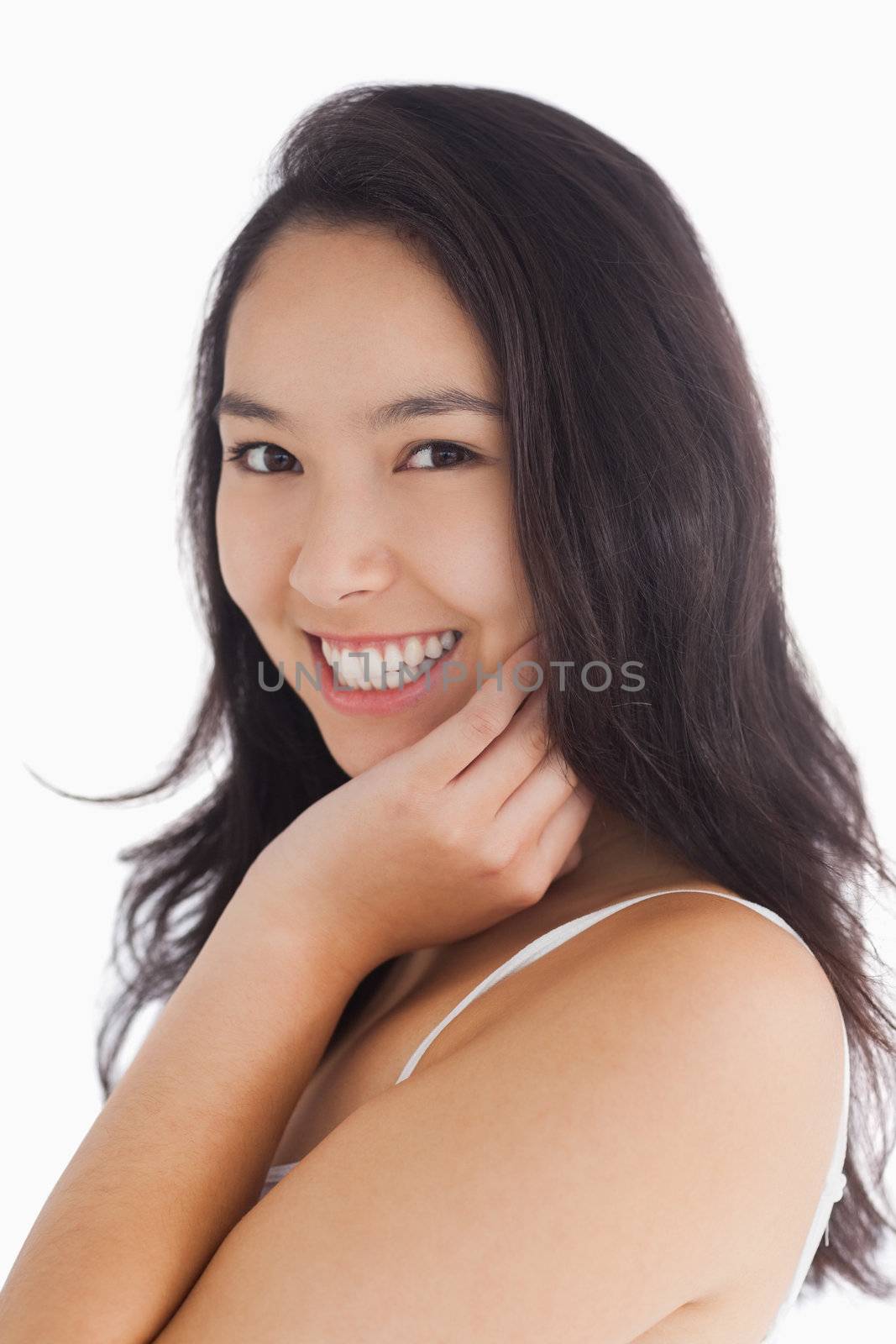 Female beauty smiling while touching her skin