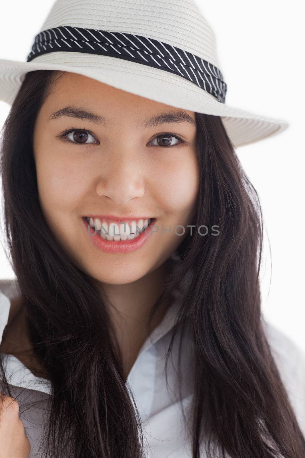 Smiling woman wearing a hat by Wavebreakmedia