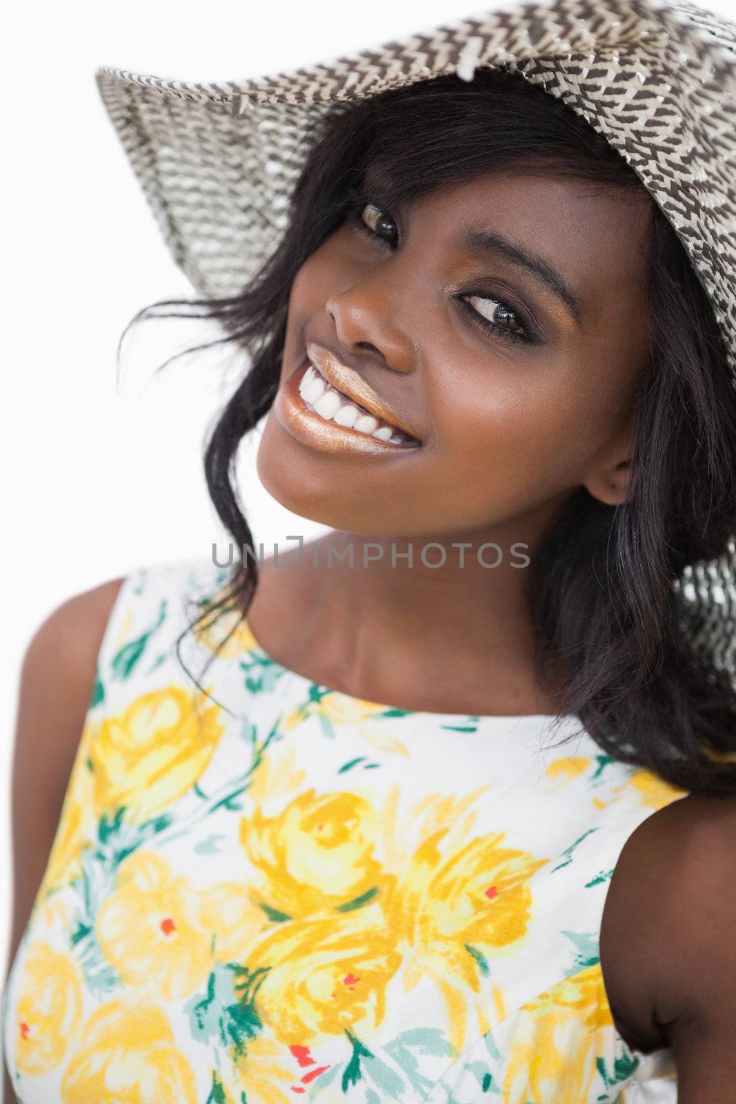 Woman standing wearing a summer hat smiling 