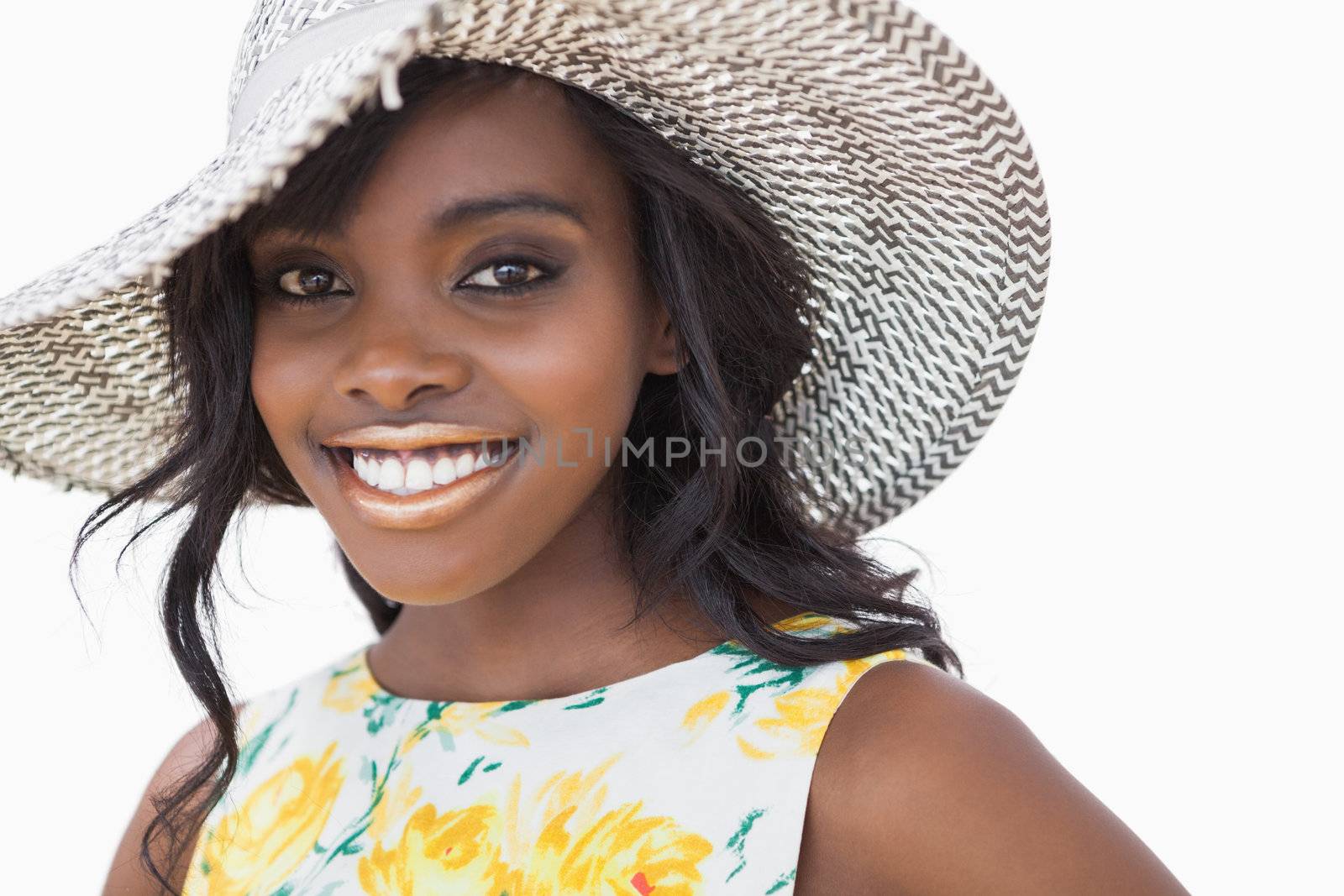 Woman wearing summer hat against white background 