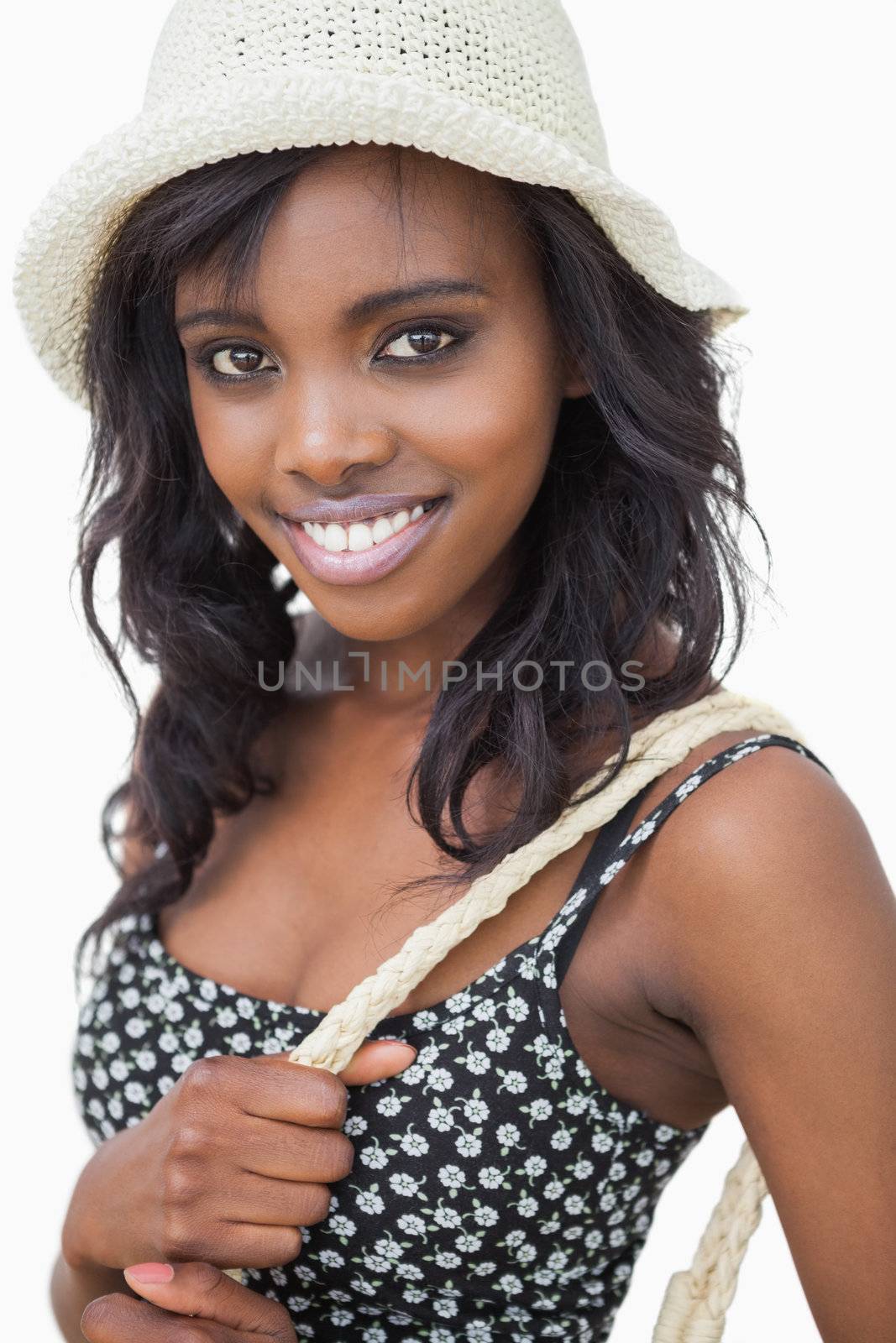 Woman wearing summer hat and black flower dress by Wavebreakmedia