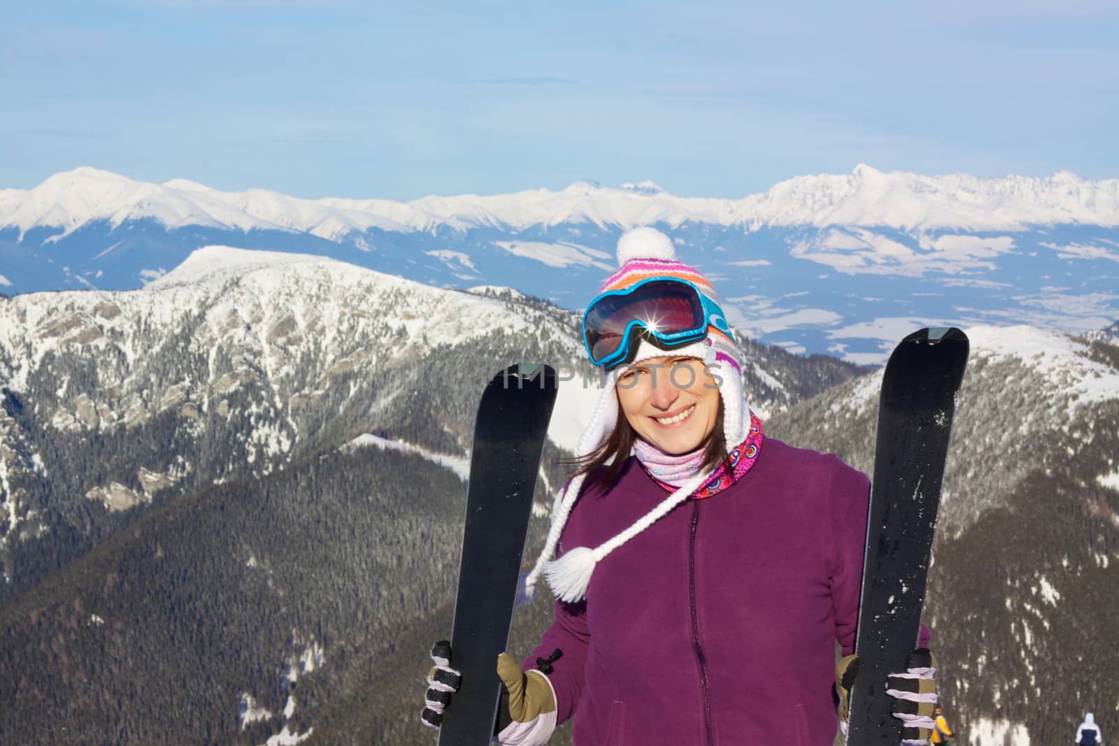 Pretty girl in mountains skiing by Harvepino