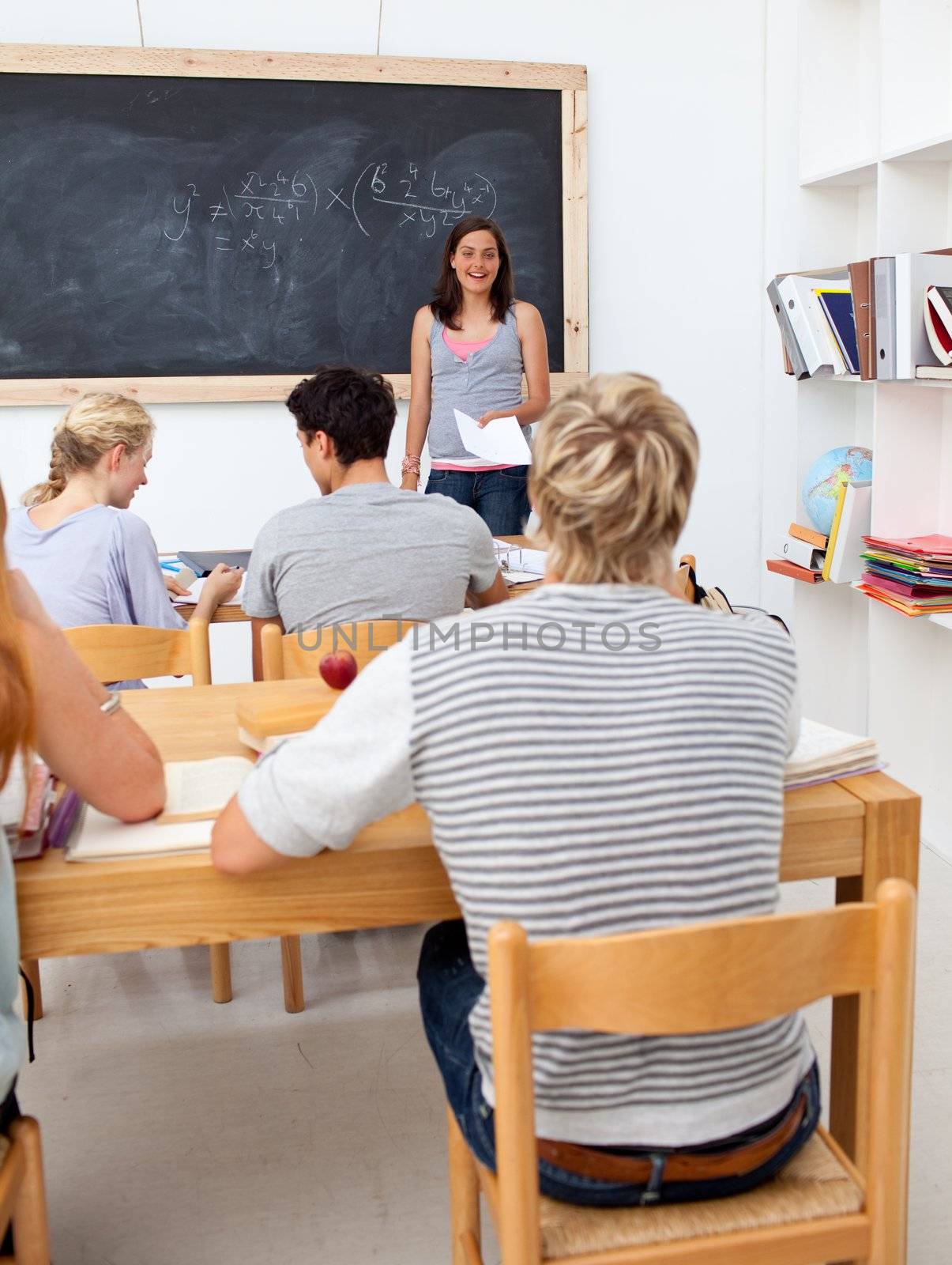 Teenagers studying together in a class by Wavebreakmedia