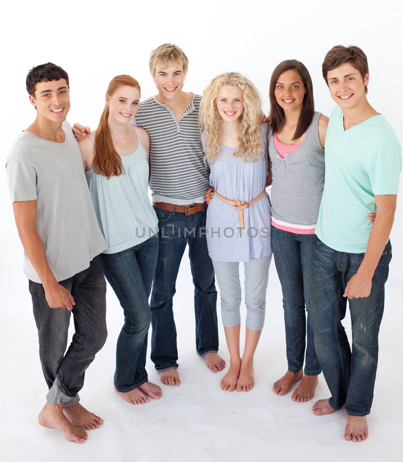 Group of friends standing against white background by Wavebreakmedia