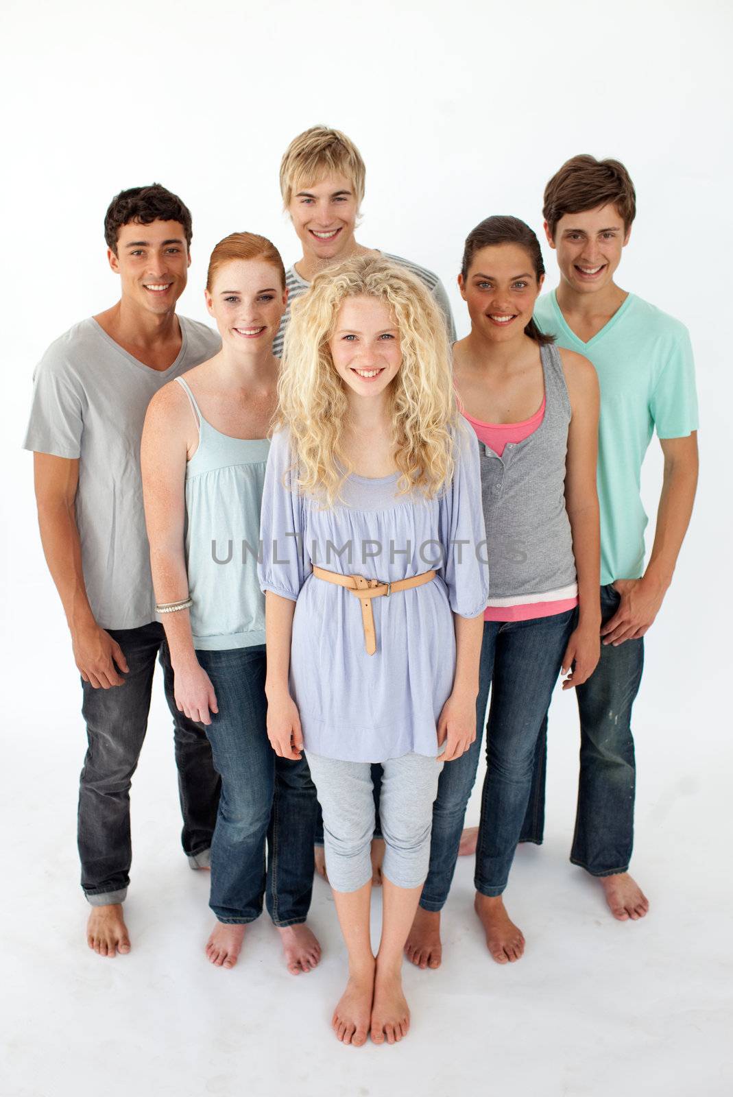 Group of teenagers standing and smiling in front of the camera