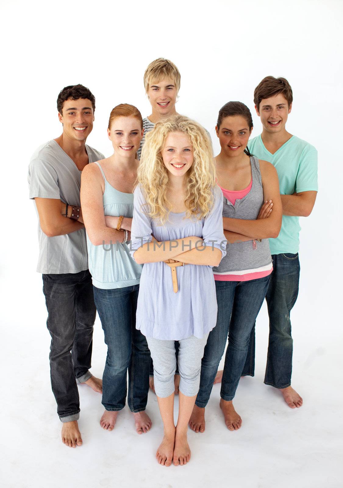 Confident teenagers standing and smiling in front of the camera