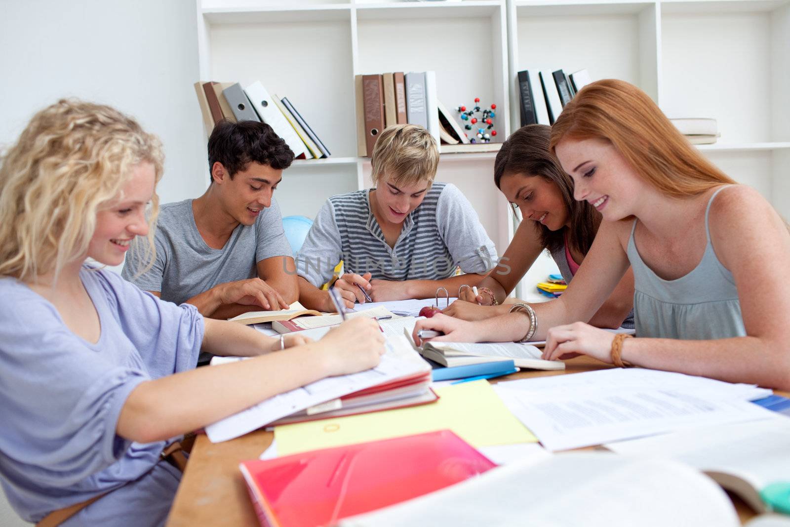 Teenagers doing homework in the library. Concept of education