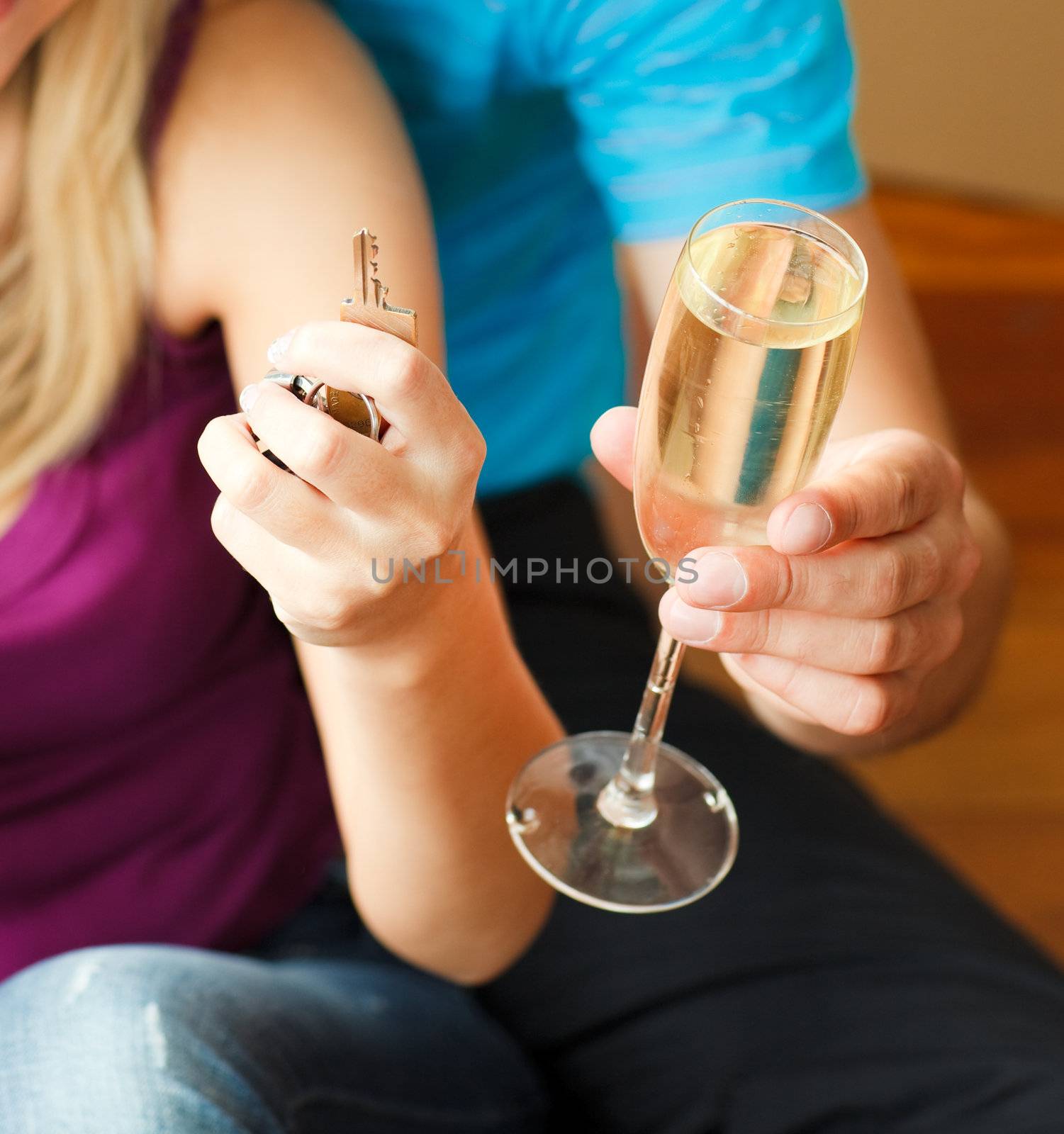 Close-up of a key and a glass of champagne. Concept of buying ho by Wavebreakmedia