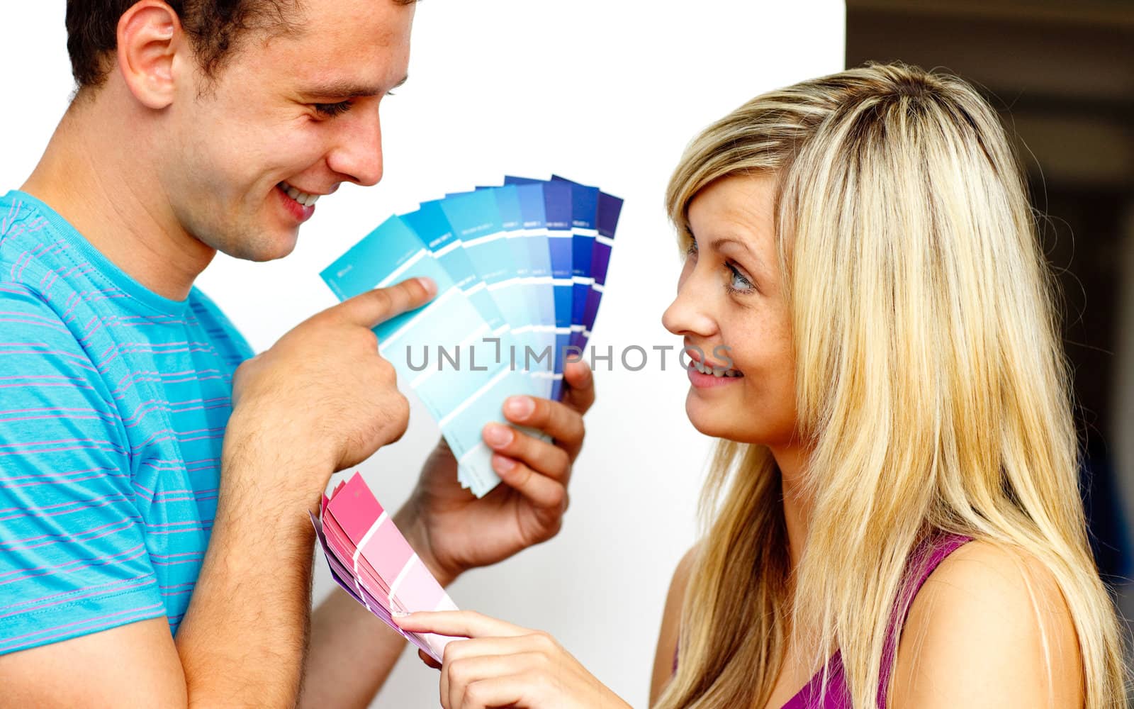 Couple with colour samples to paint new apartment. Concept of decoration