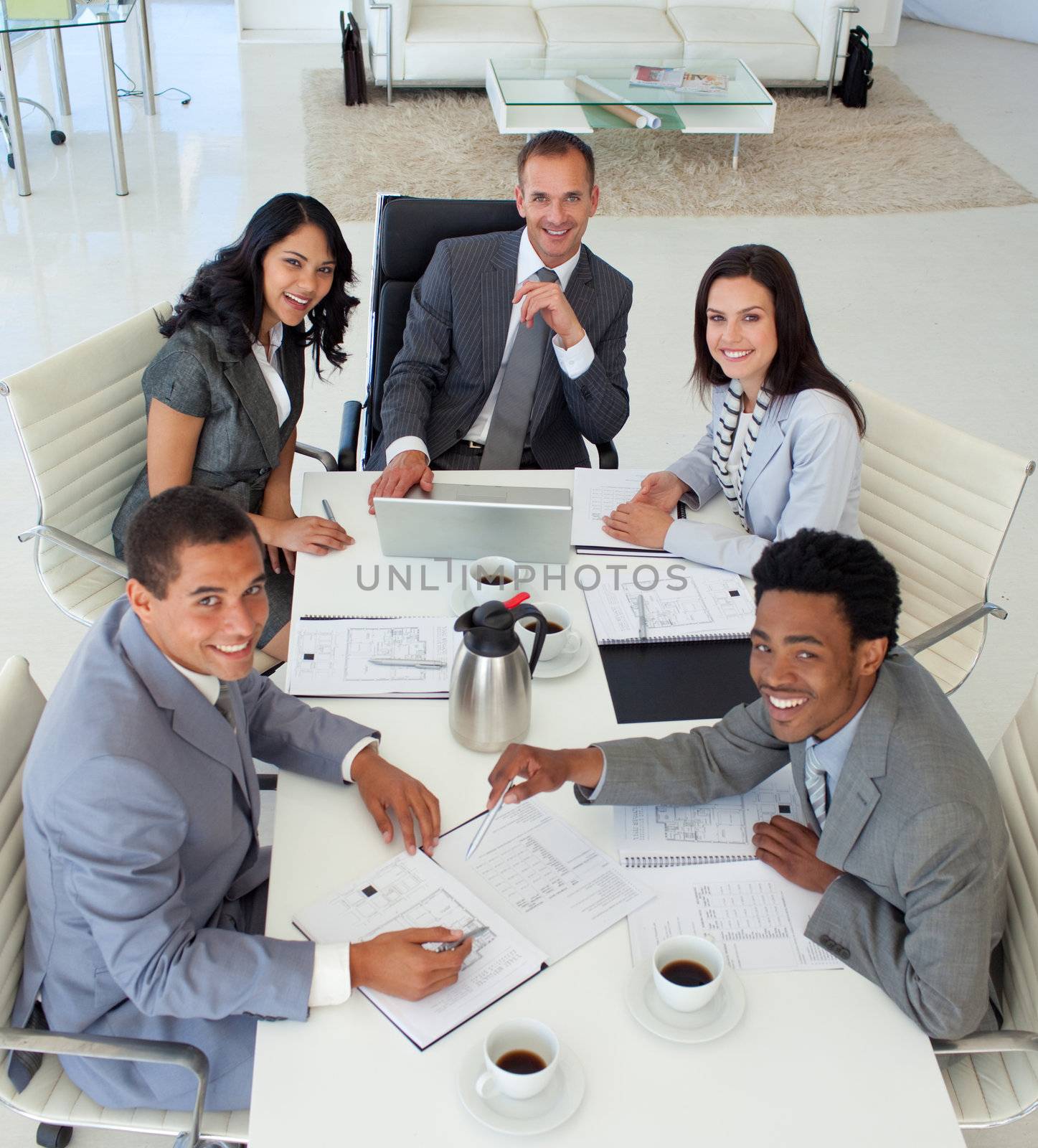 Smiling business people working in a meeting by Wavebreakmedia