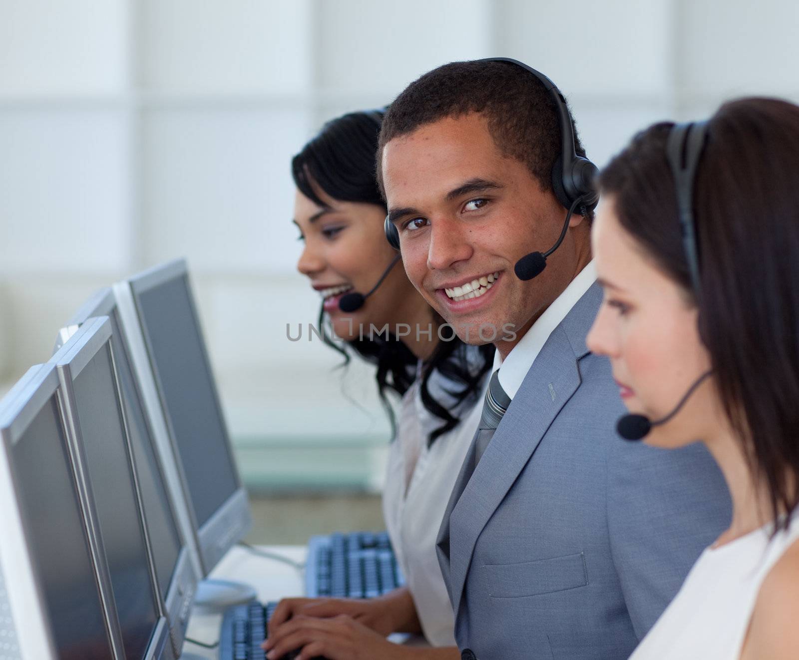 Smiling businessman working in a call canter 