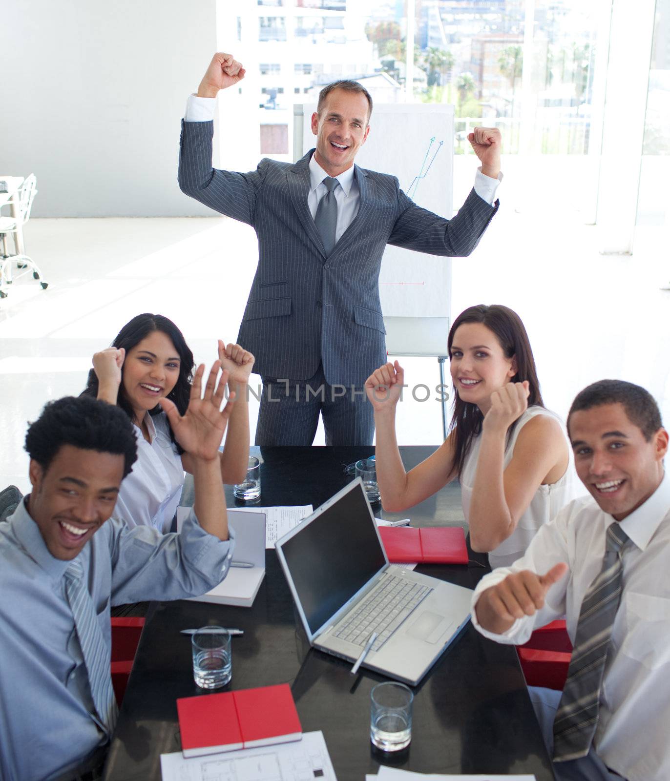 Happy business team in a meeting celebrating a success
