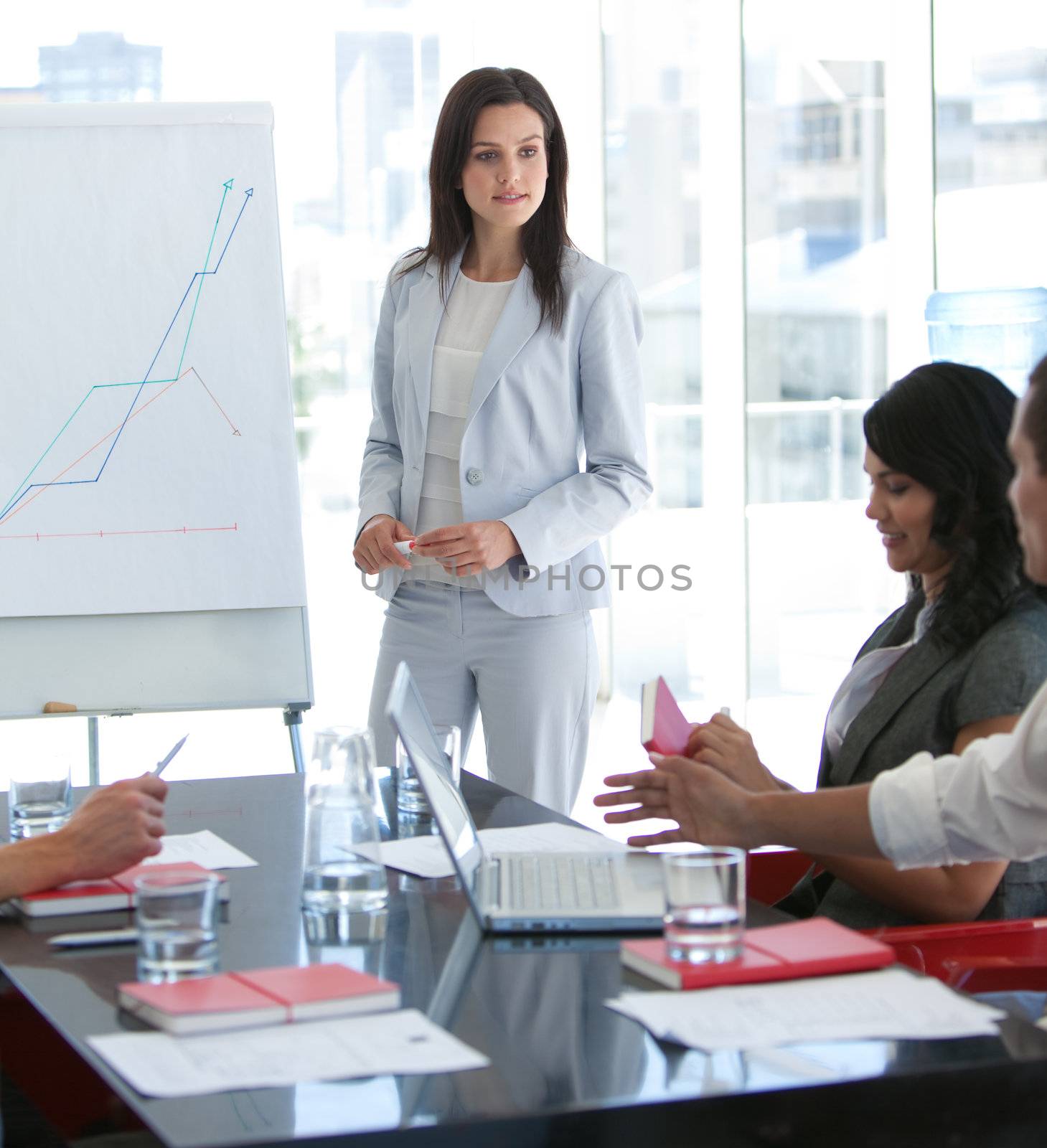 Attractive businesswoman talking to her colleague in a presentation