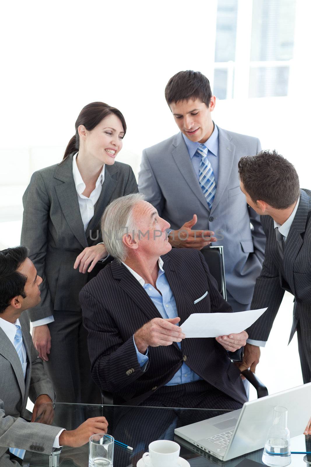 Multi-ethnic business people discussing a contract in a meeting