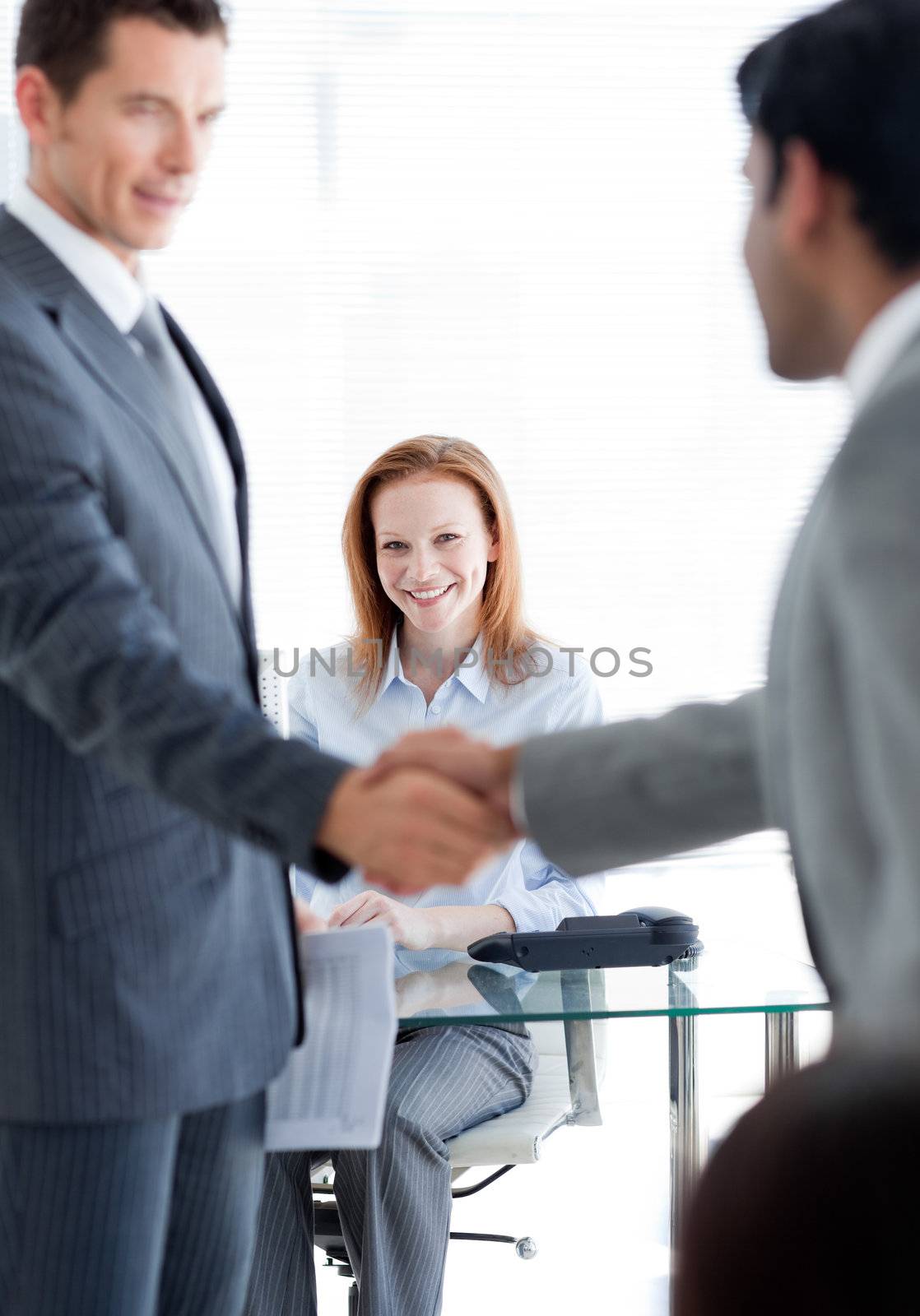 International businessmen greeting each other at a job interview in an office