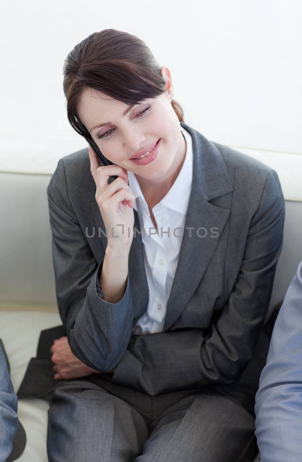 Smiling businesswoman on phone while waiting for a job interview by Wavebreakmedia