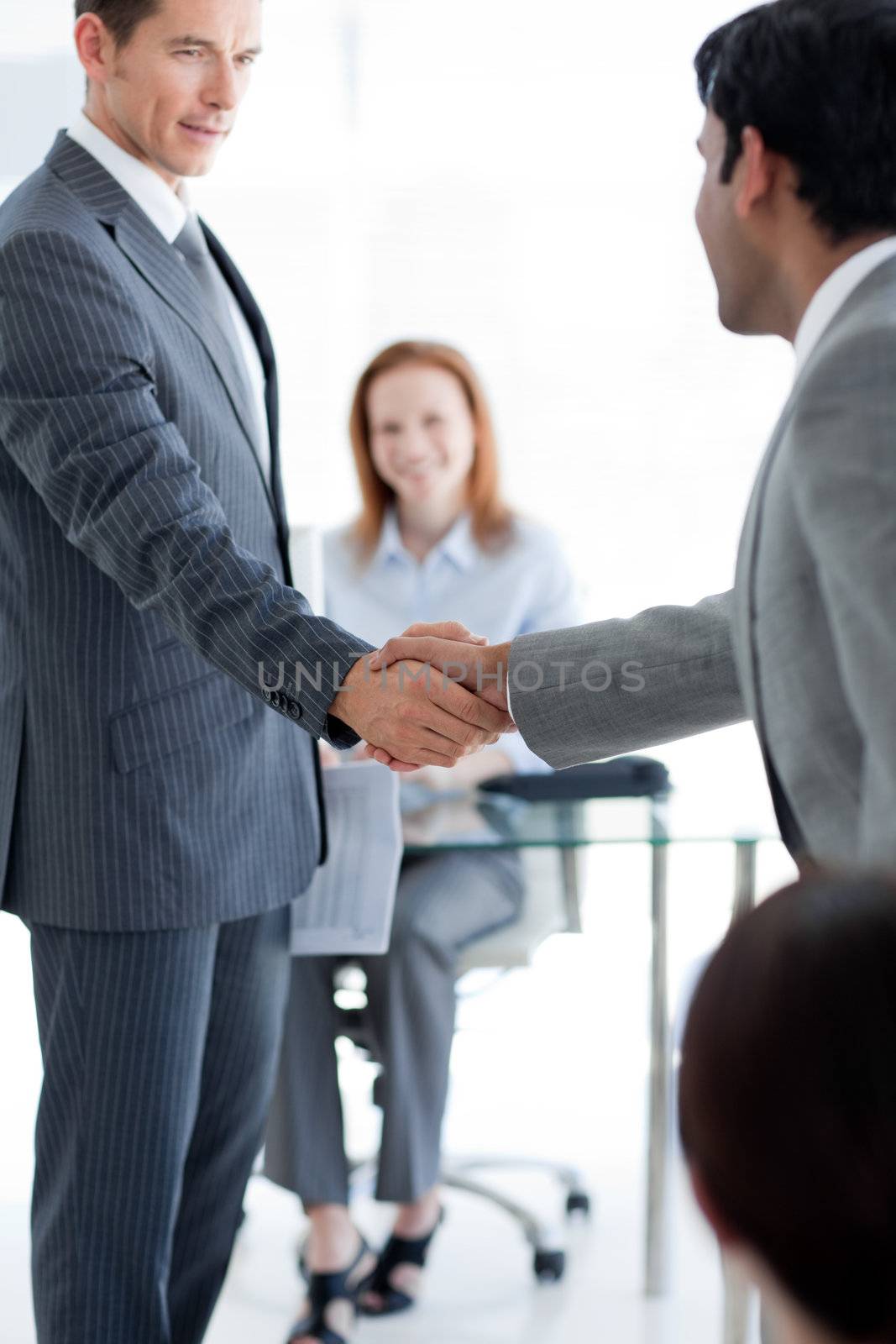 Businessmen greeting each other at a job interview in an office