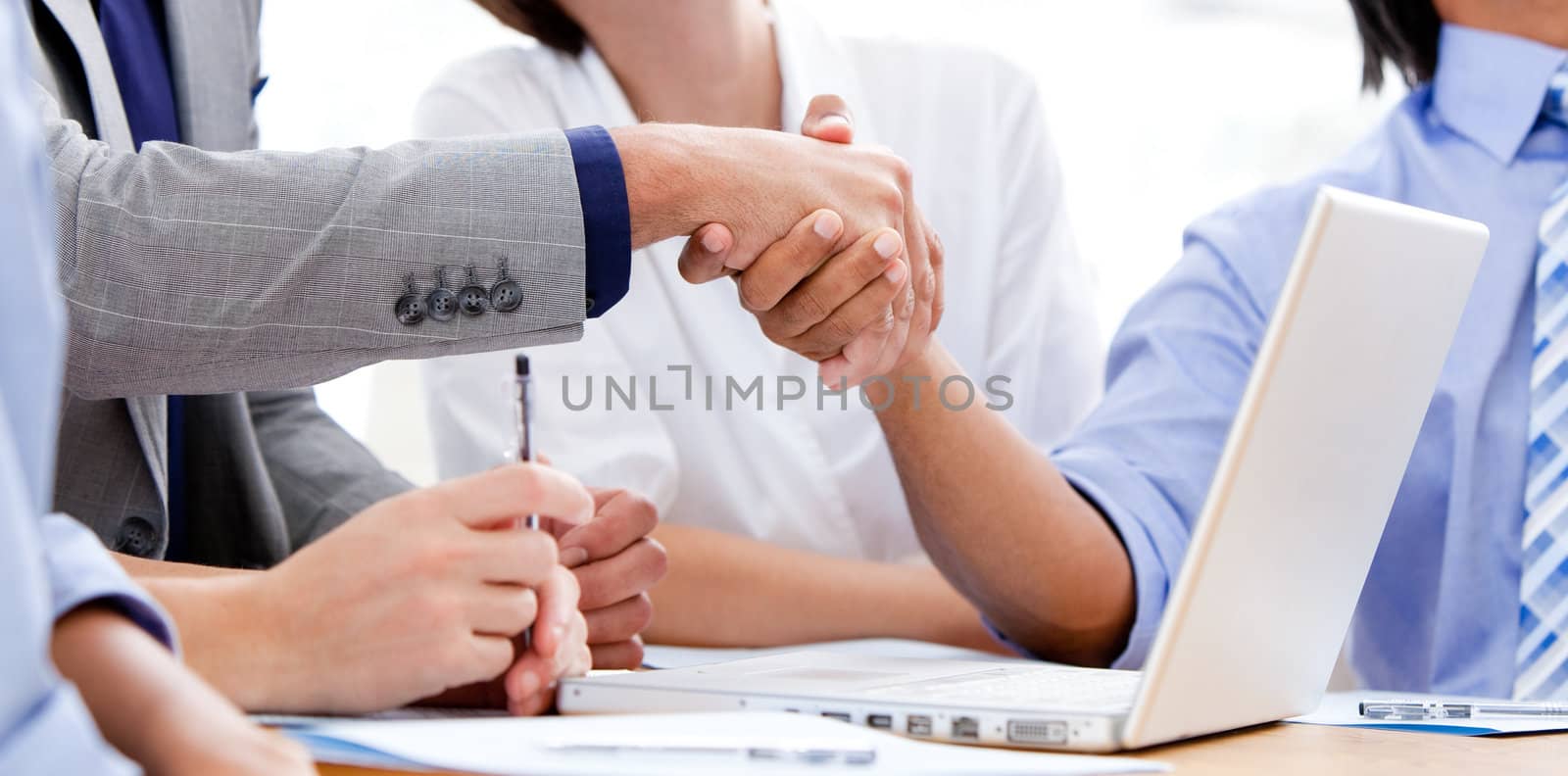 Close-up of business partners shaking hands  by Wavebreakmedia