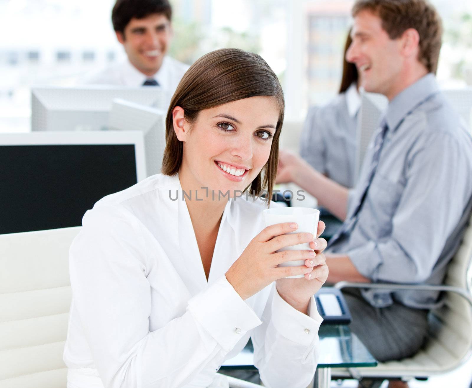 Smiling businesswoman holding a cup of tea in the office