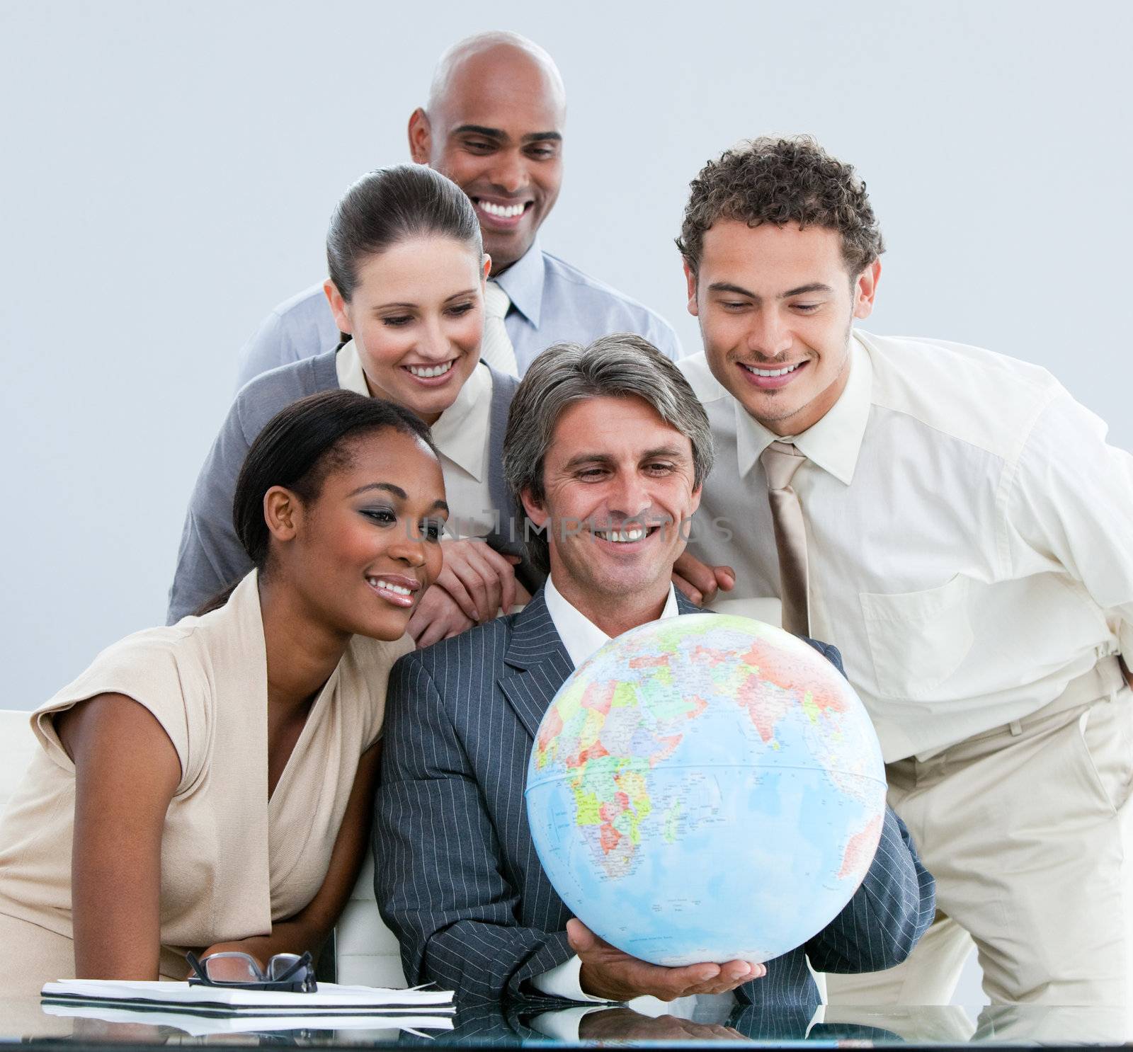 United businessteam holding a globe  globalization concept by Wavebreakmedia