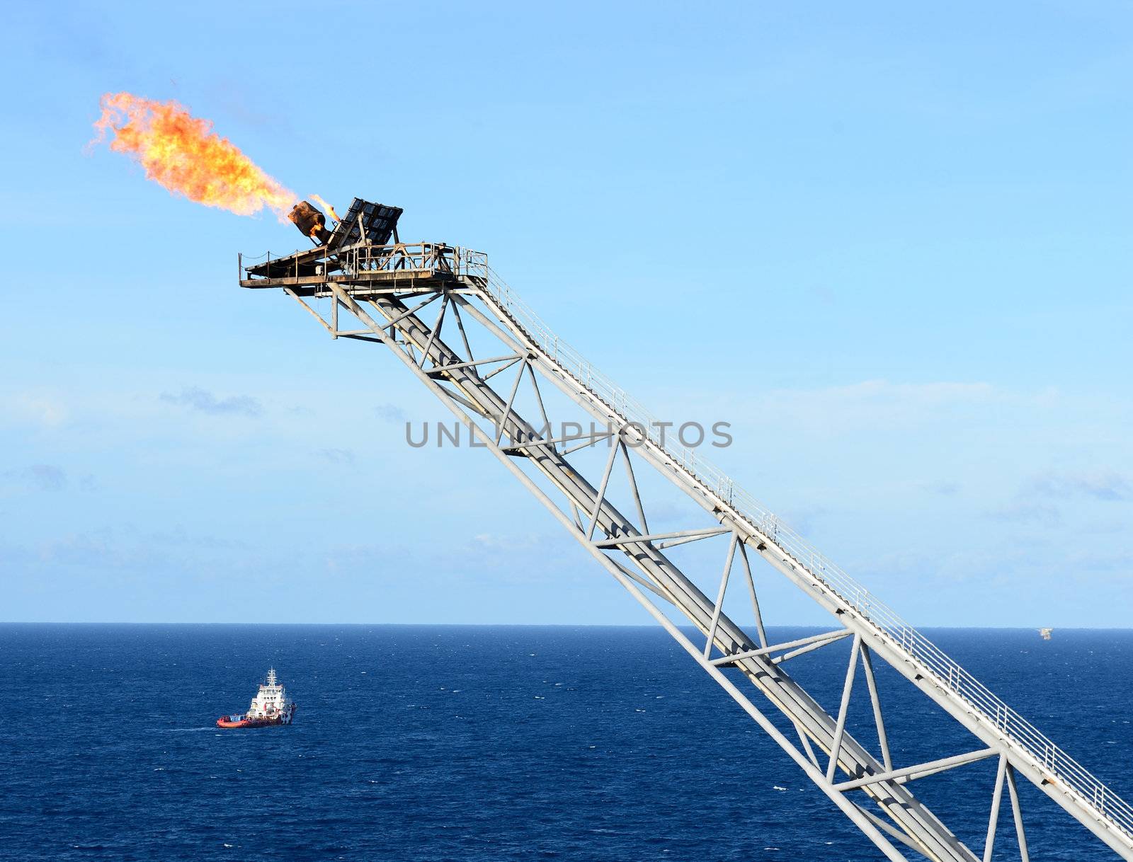 The gas flare is on the oil rig platform.