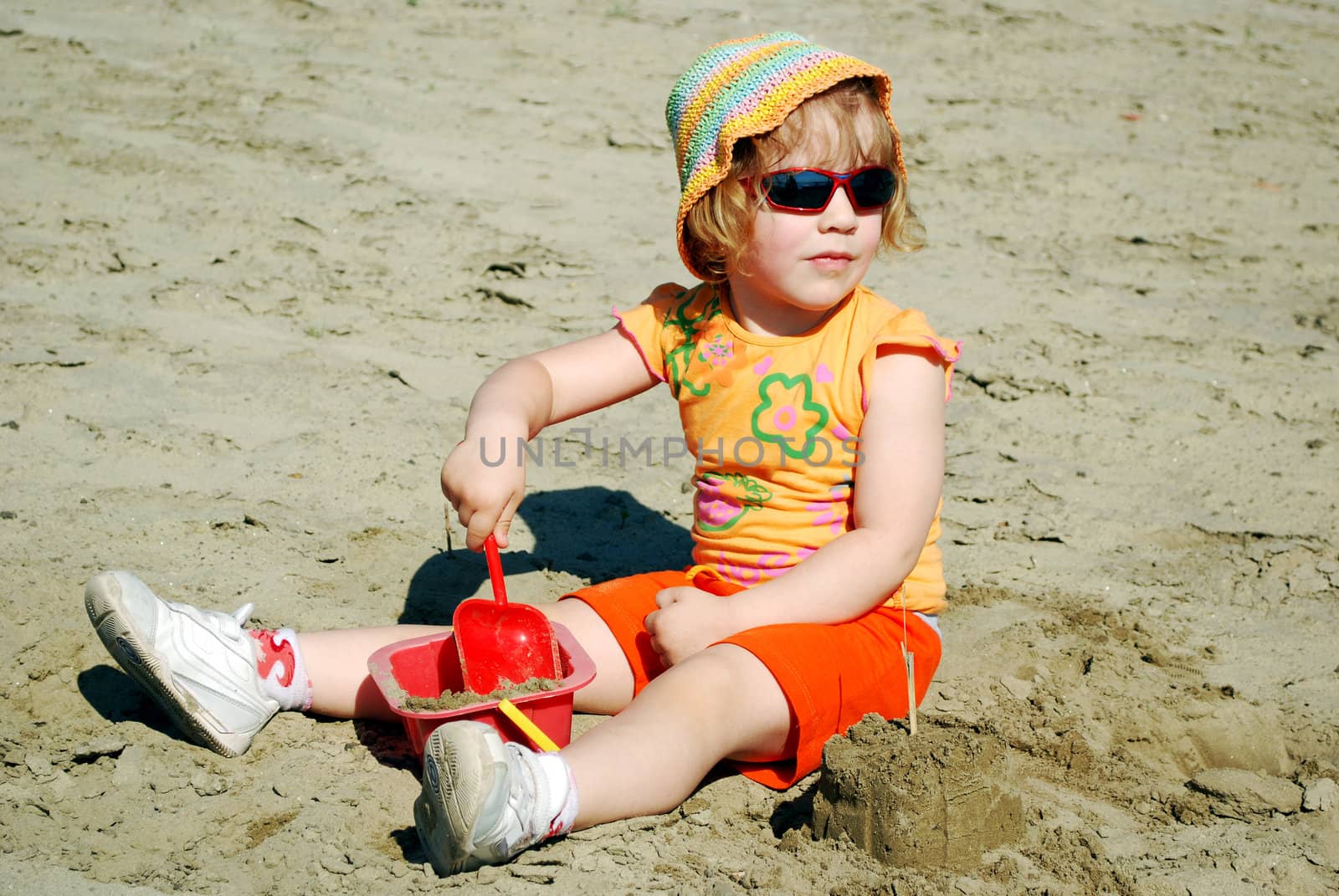 Beauty little girl playing on beach