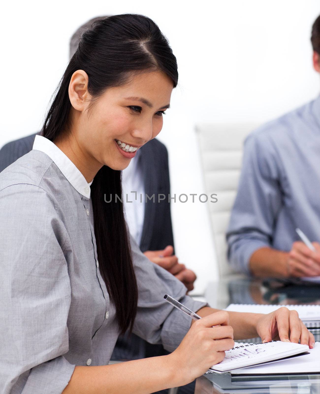 Happy female executive studying a document in a meeting