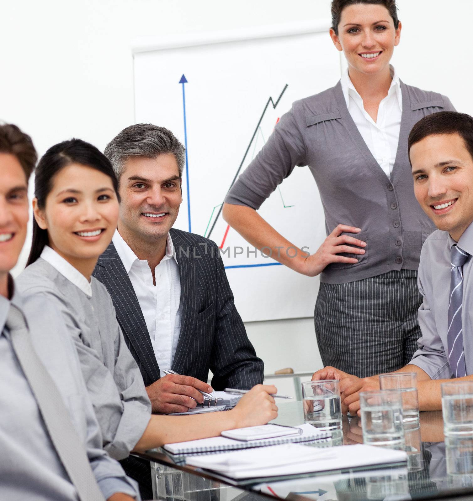 A diverse business team at a presentation smiling at the camera