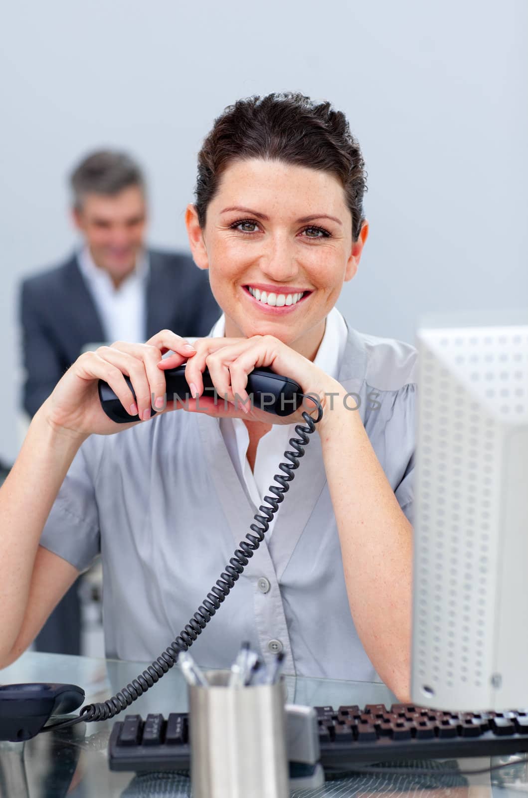 Brunette business woman on phone in the office