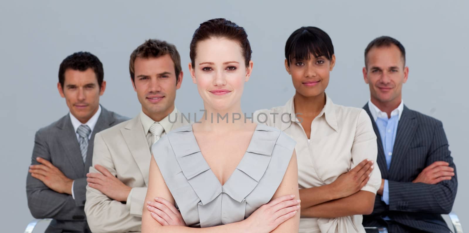 Confident multi-ethnic business team with folded arms by Wavebreakmedia